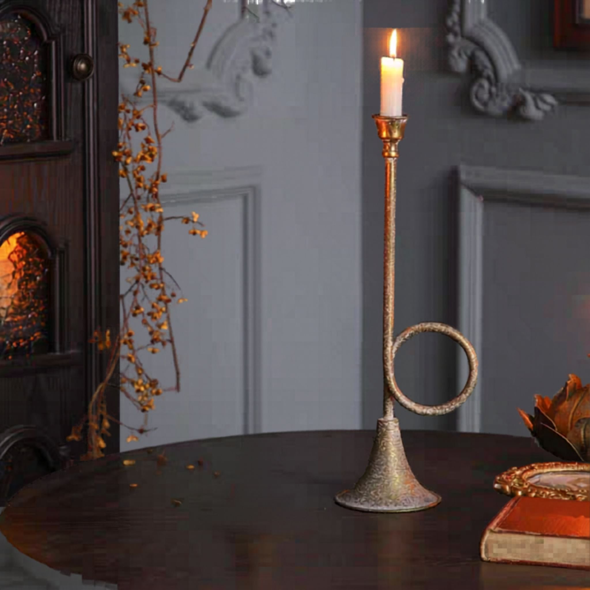 Arnaud horn candle holder lit with a white taper in a French country interior