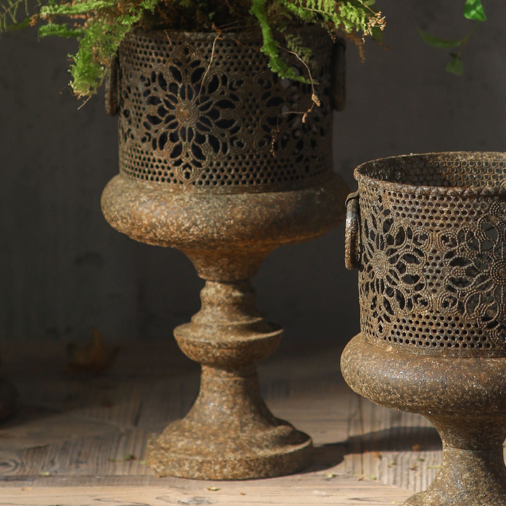 Arthur pedestal planter close-up of the pierced floral cutwork and pedestal foot