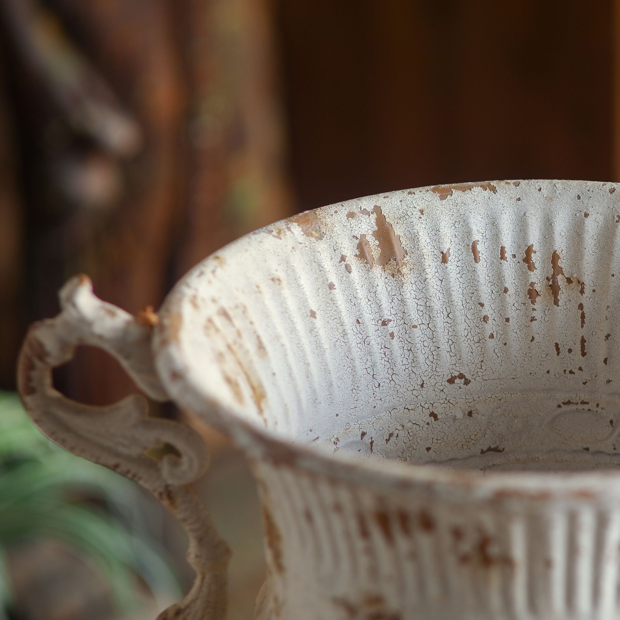 Close-up of the Benoît urn fluted rim and interior with crackled antique-white paint.