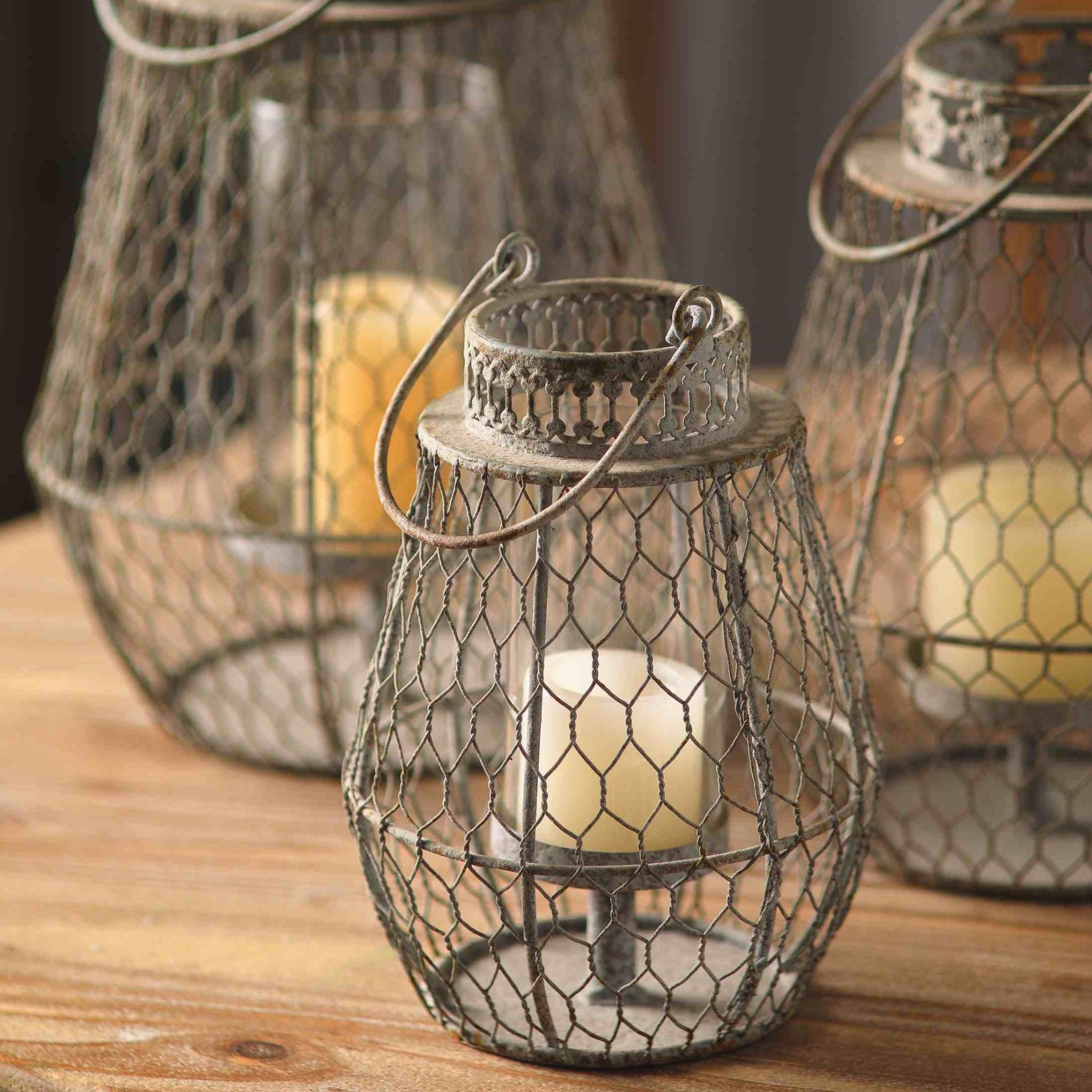 The small Berenice lantern in front with its beaded collar, shown beside the larger Martine and Louise.