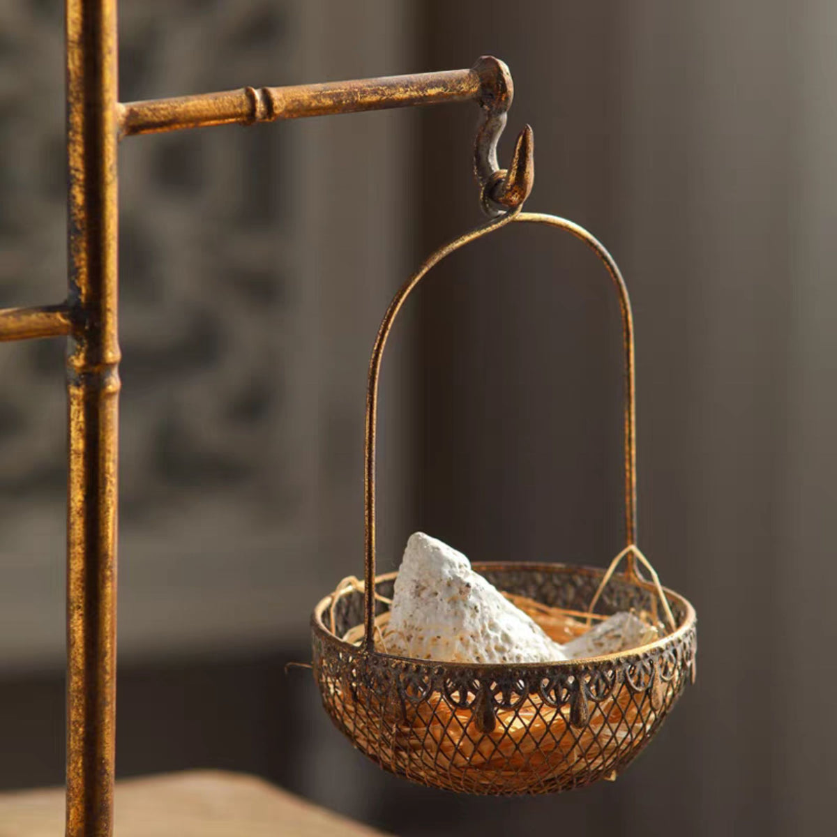 Bertrand basket stand with one removable basket holding pale crystals.