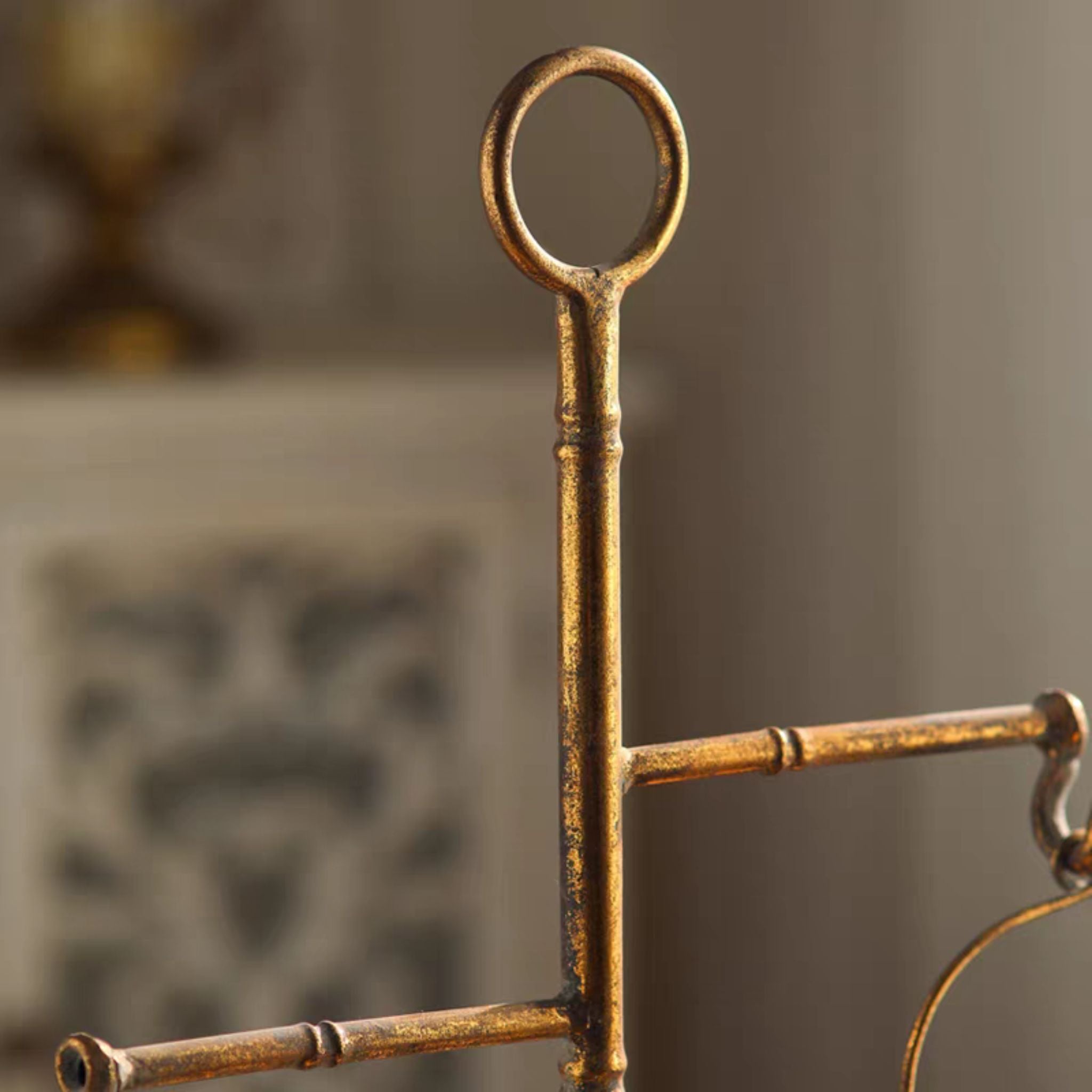 Bertrand basket stand detail of the ring top, faux-bamboo post and hooked arm in aged antique gold.