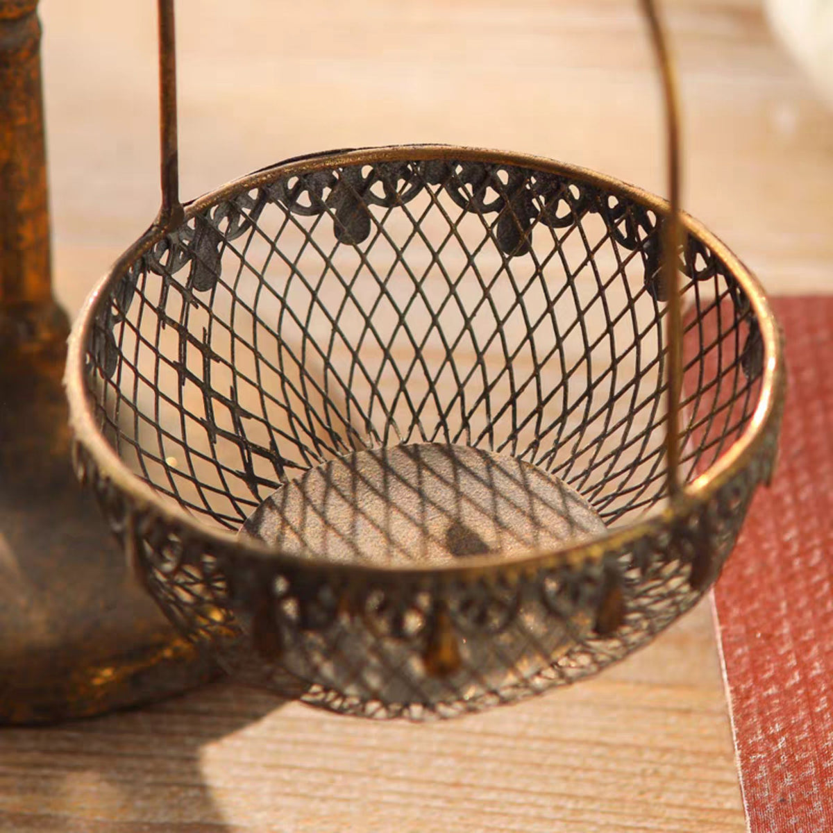 Bertrand basket stand close-up of the diamond wire mesh and pierced scalloped trim on one basket.