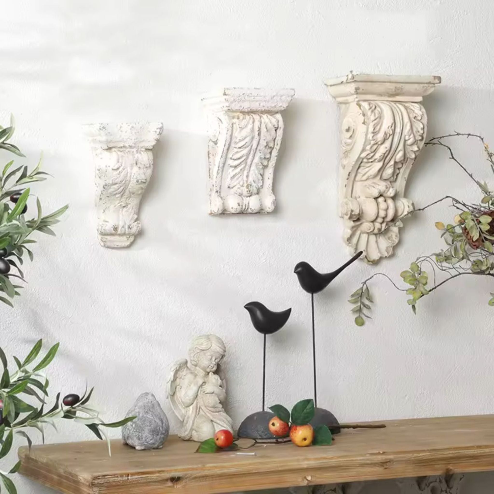 Brigitte corbel wall sconce styled on a plaster wall alongside larger corbels, showing the graduated sizes