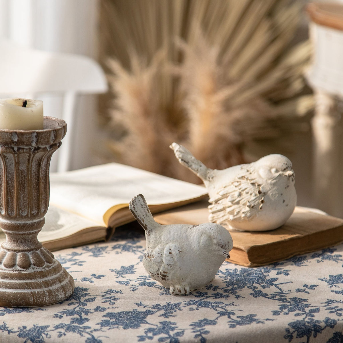 Close view of the Cameron bird figurines showing the carved wing feathers and the warm base tone worn through the whitewash
