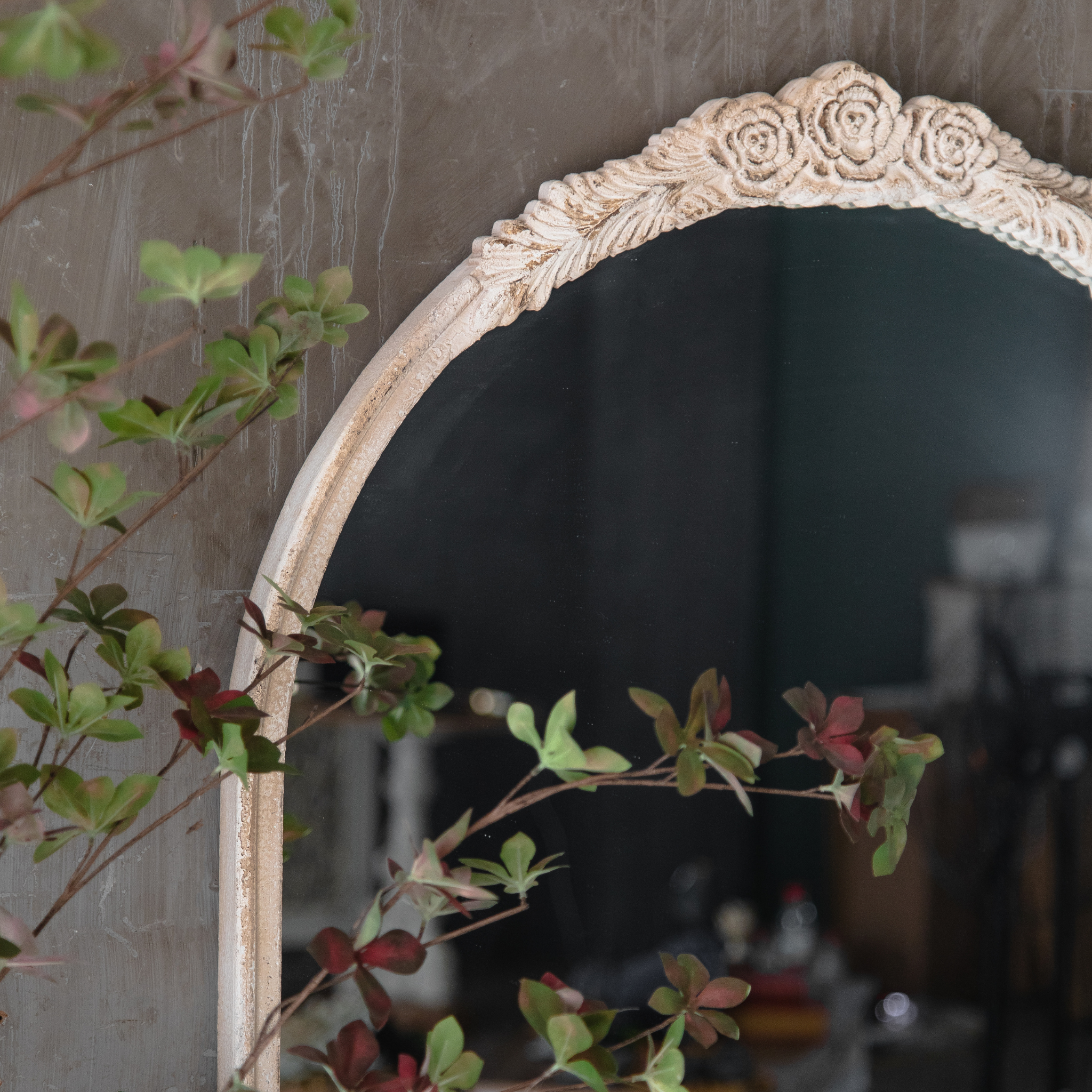Detail of the rose and leaf crown ornament on the Camille arched wall mirror