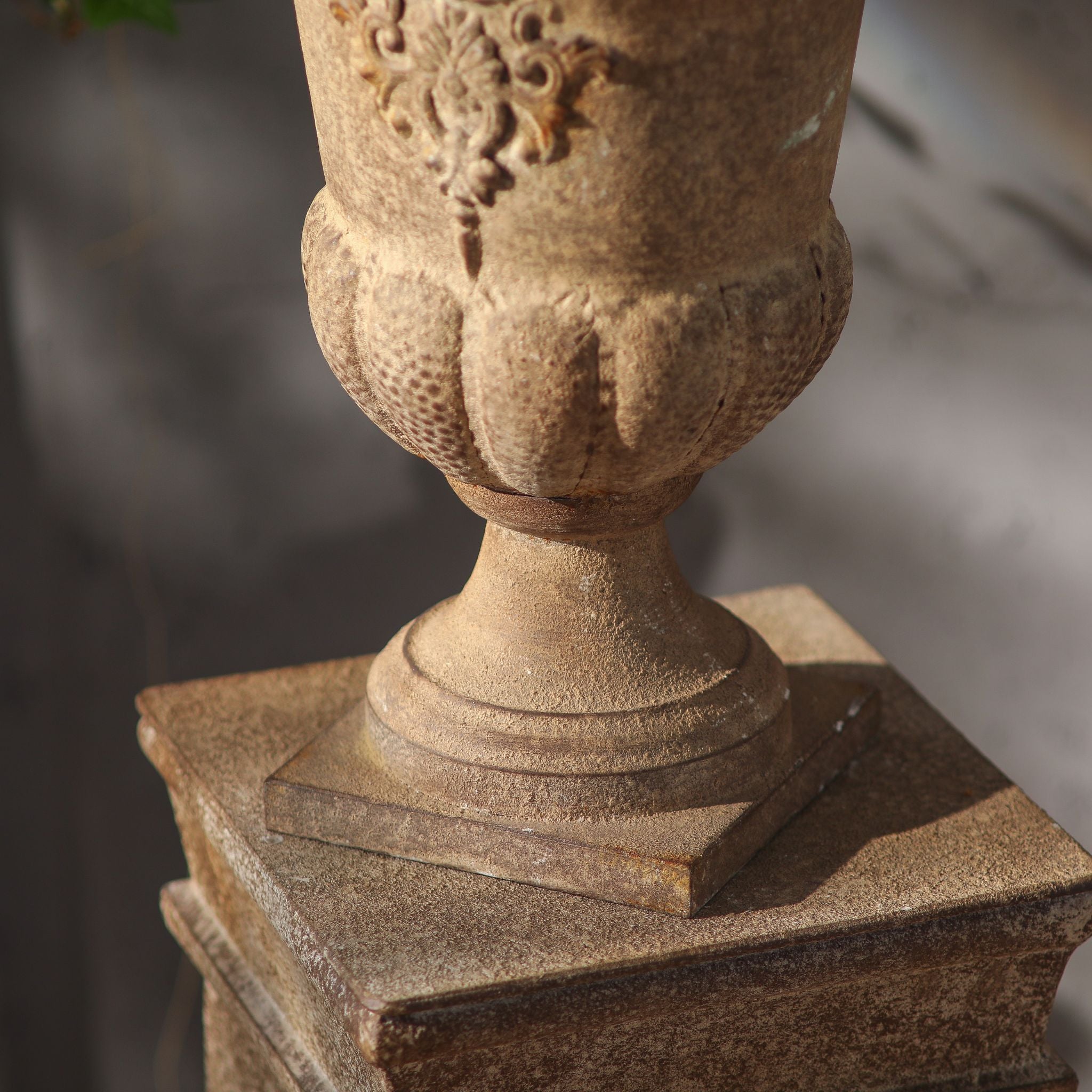 Close-up of the fluted lower body and footed base of the Delphine urn