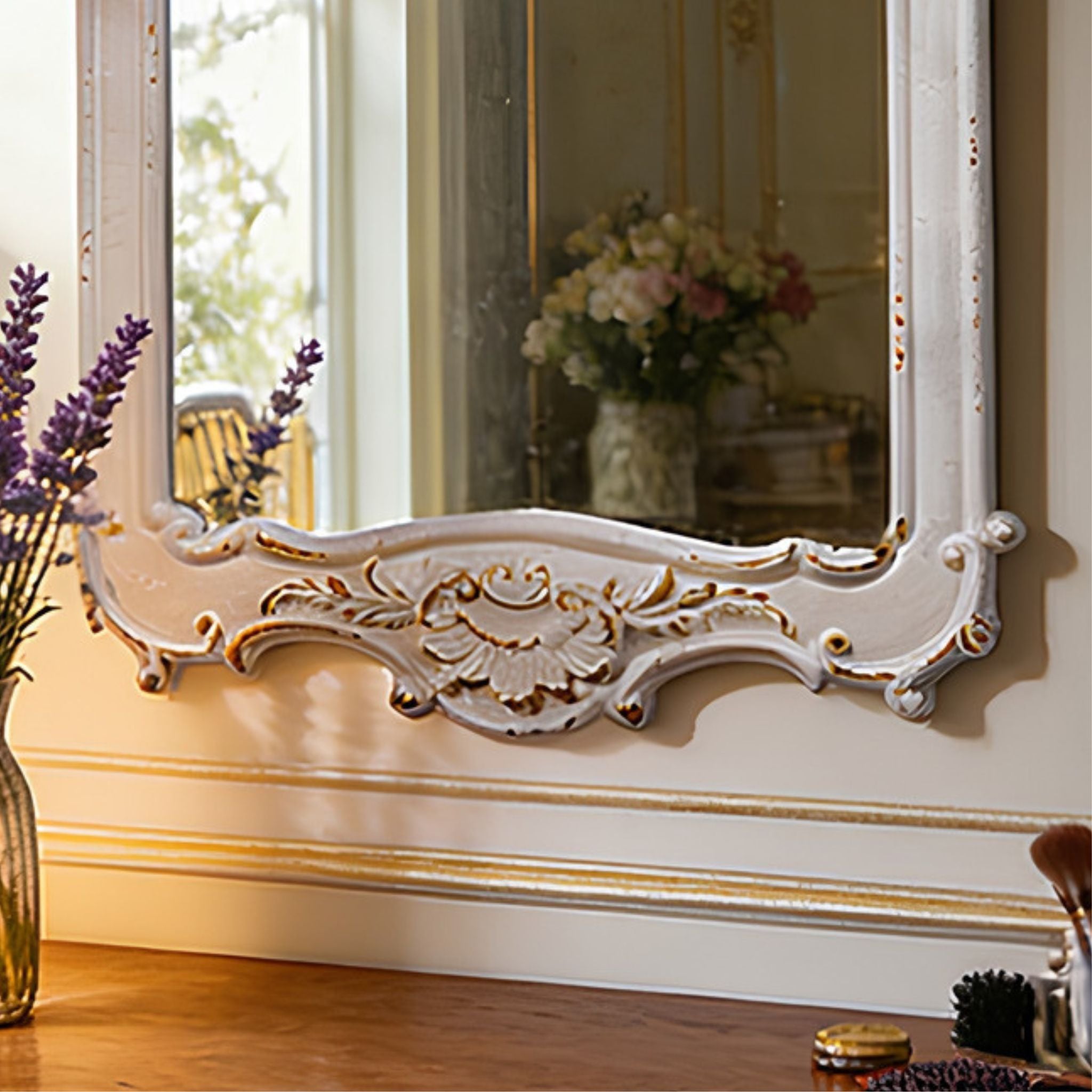 Close-up of Chambord's matching lower cartouche showing the central rosette, scrolling acanthus and the hand-finished antique white with gold accents worn back at the high points.