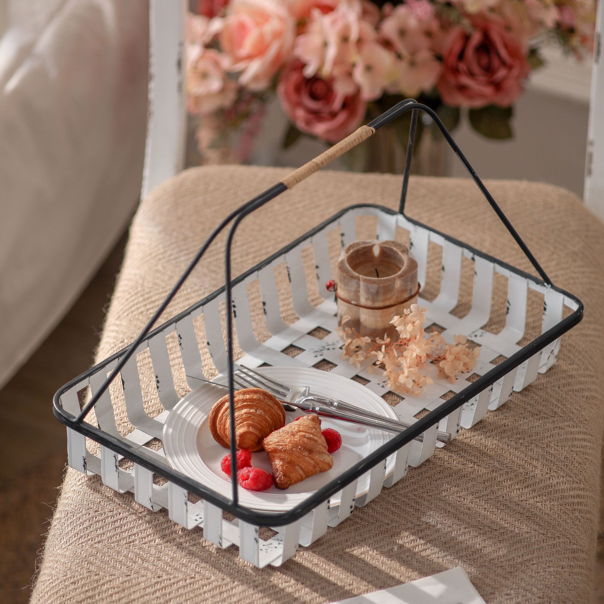 Chantal French Provincial metal carry basket with woven straps and a tall folding handle in distressed white