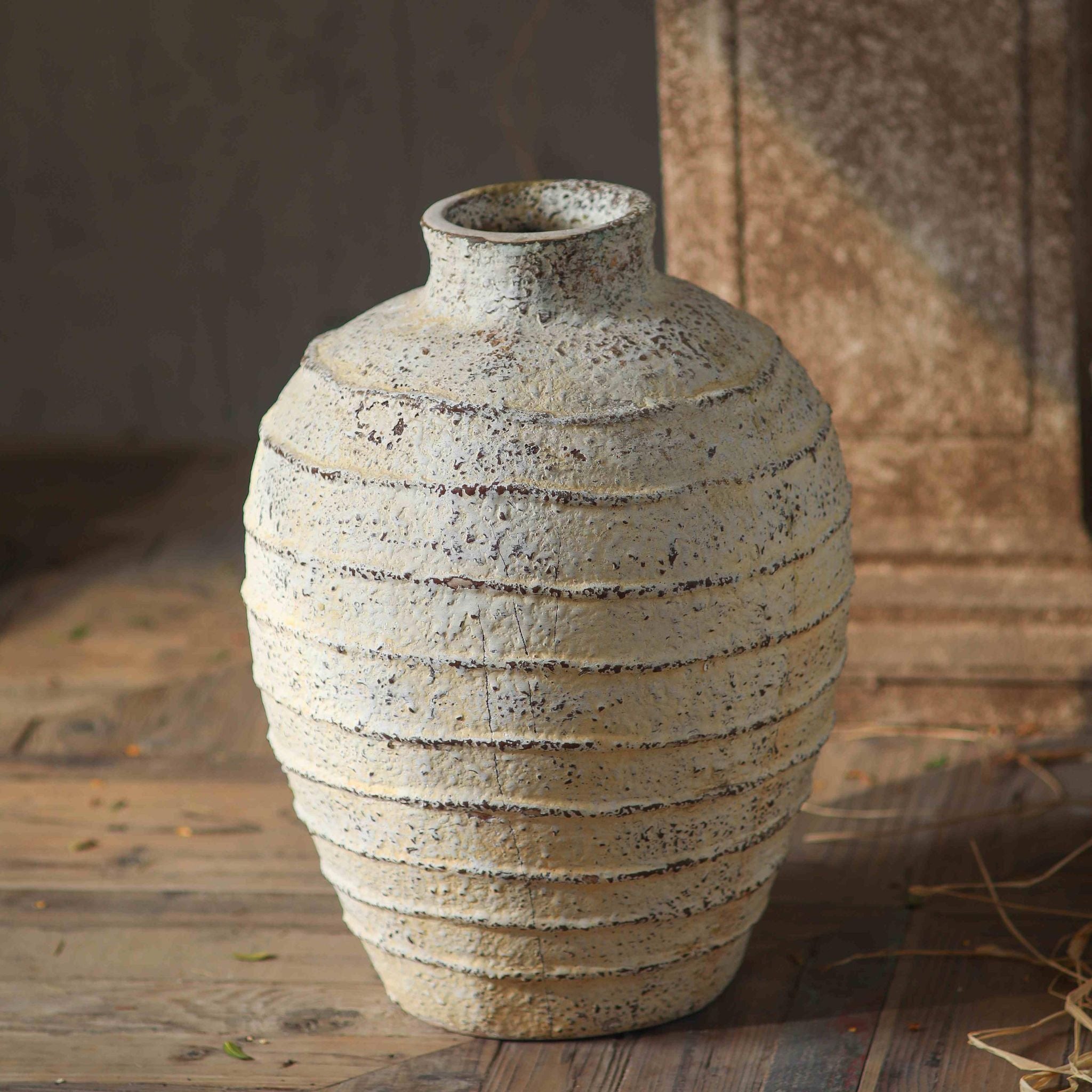 Charles ribbed cream stone vase, front on, showing the banded body. 