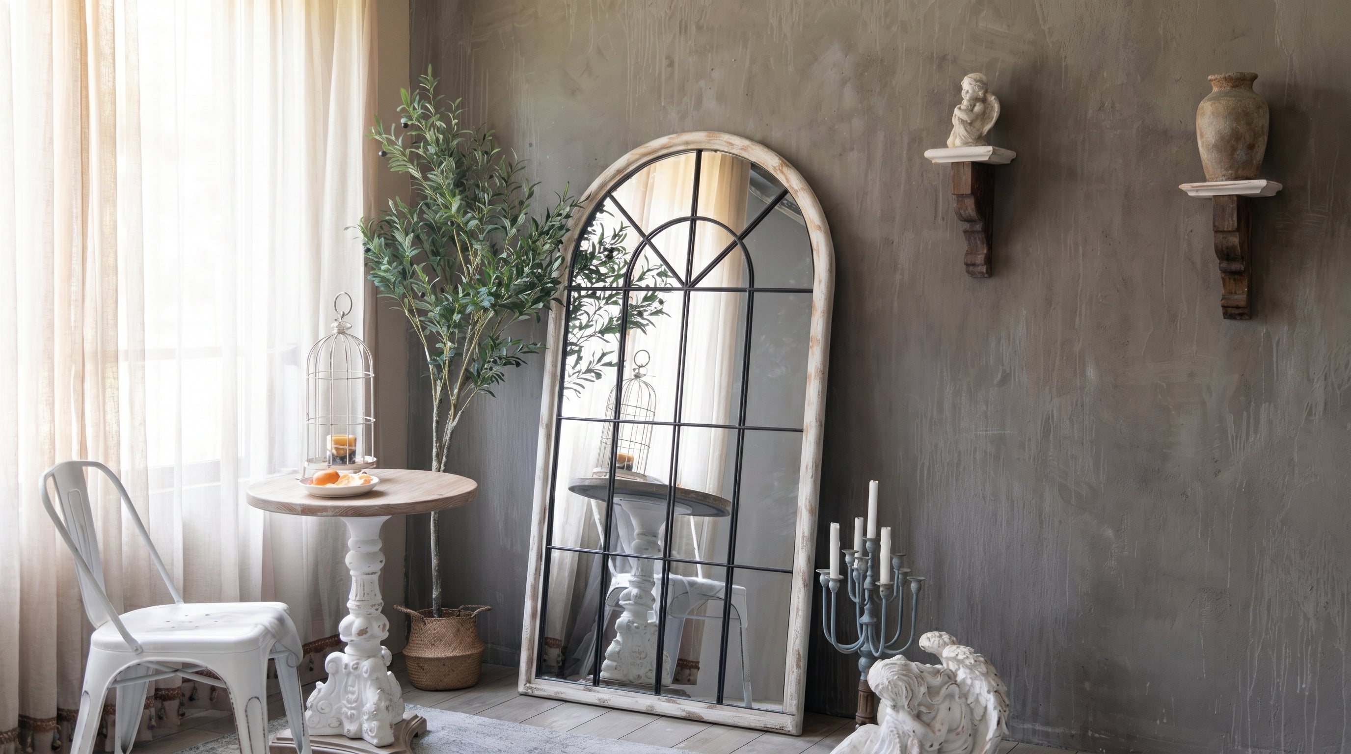 Decorative interior with a large mirror, plants, and wall art on a gray wall.