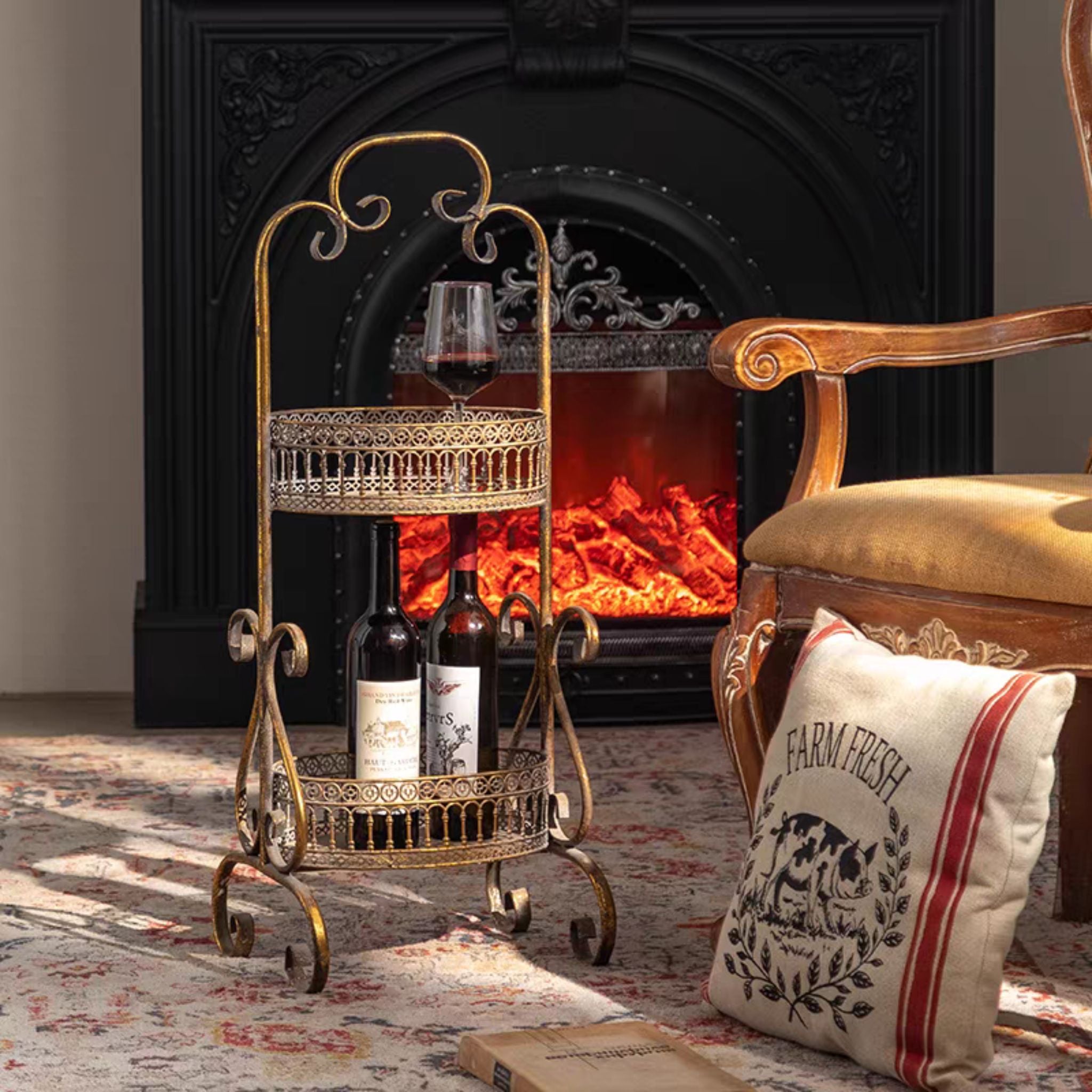 Claudine two-tier metal stand seen at an angle, scrolled frame and curled feet