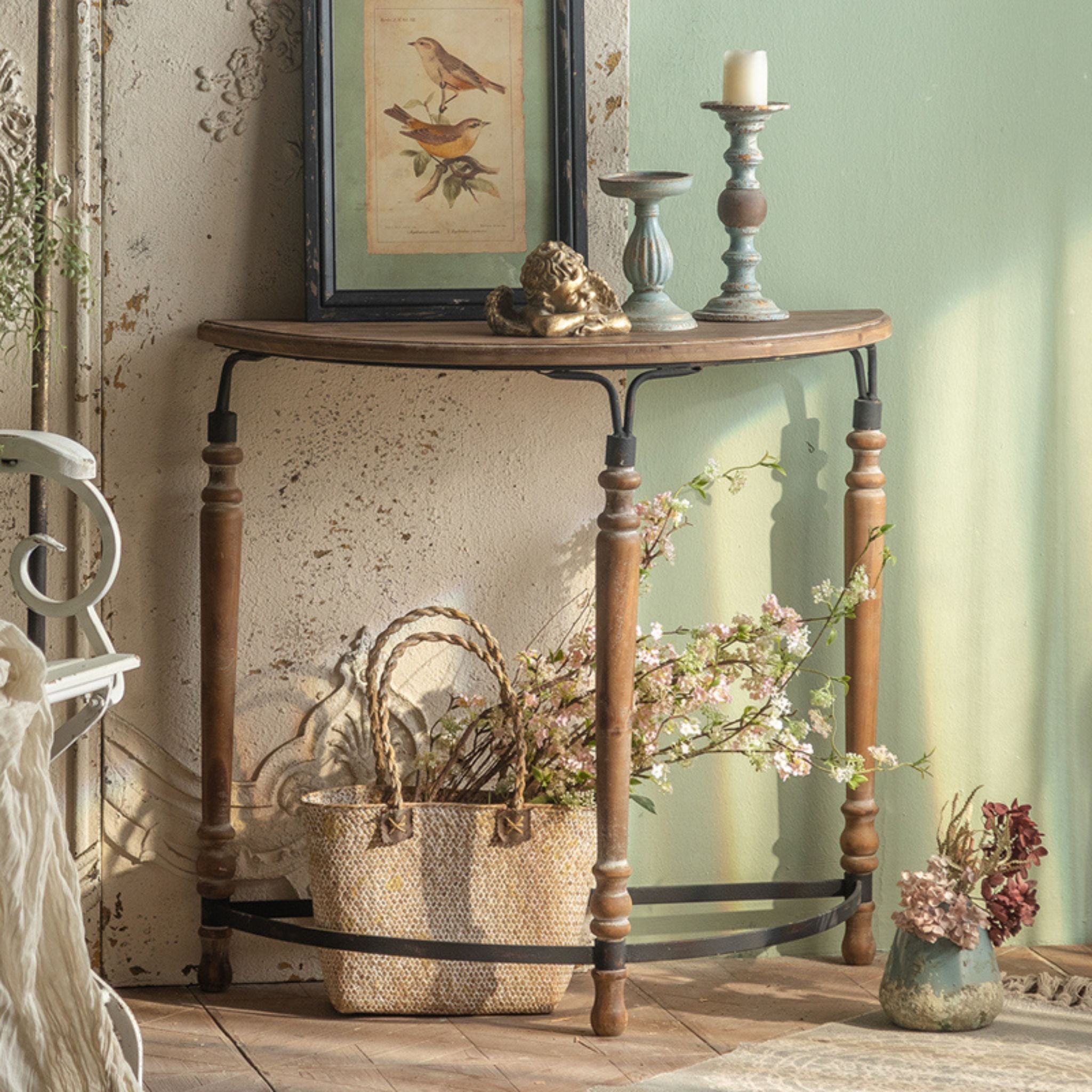 Clémence half moon console table three-quarter angle showing all three turned walnut timber legs and the curved black iron base stretcher.