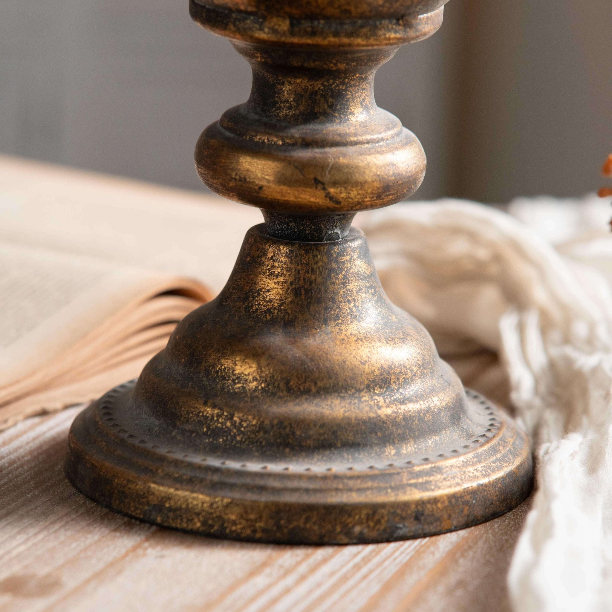 Detail of the Coralie urn vase turned pedestal foot in aged gold metal