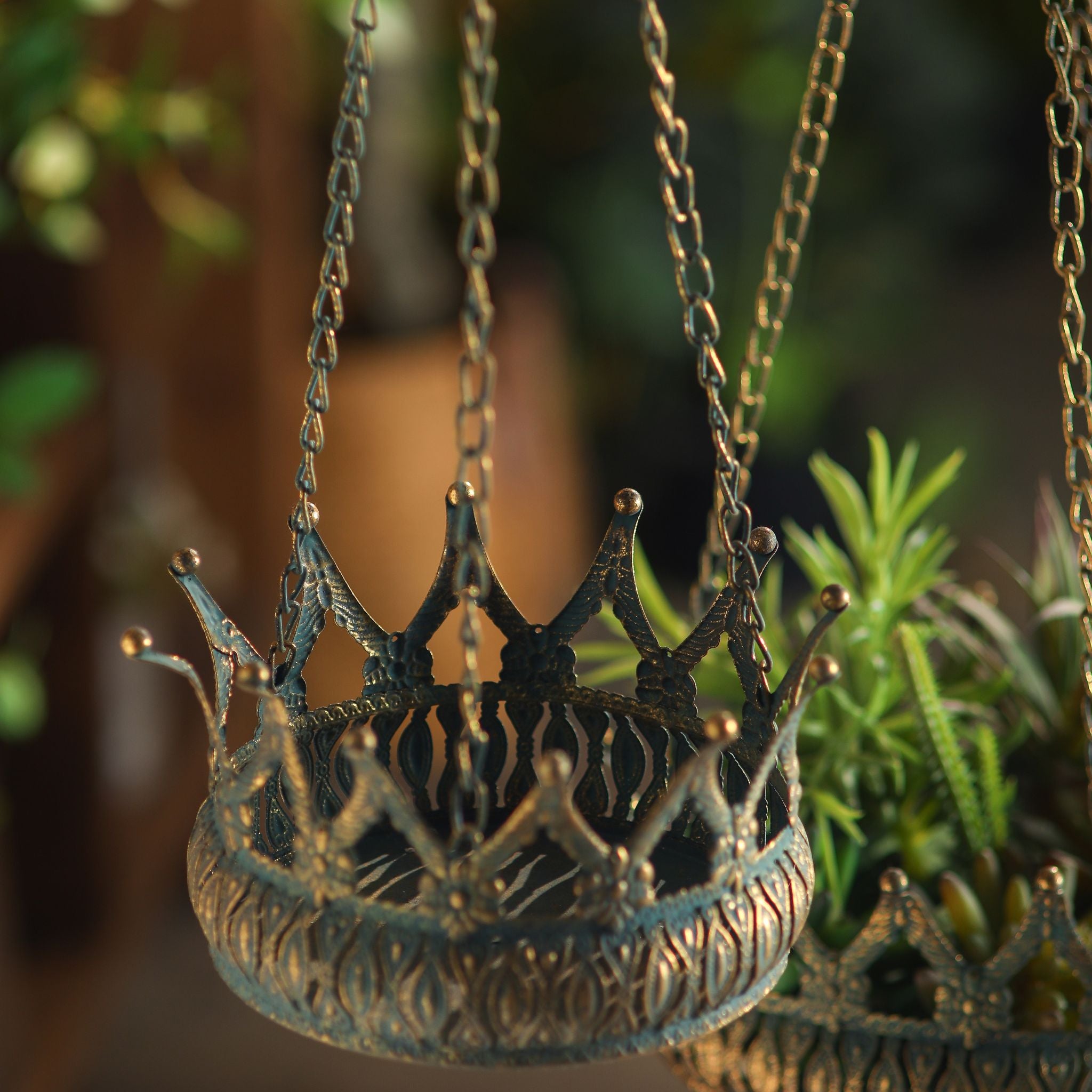 Close-up of the crown points and embossed band on the Annabelle hanging planter, Larger companion below