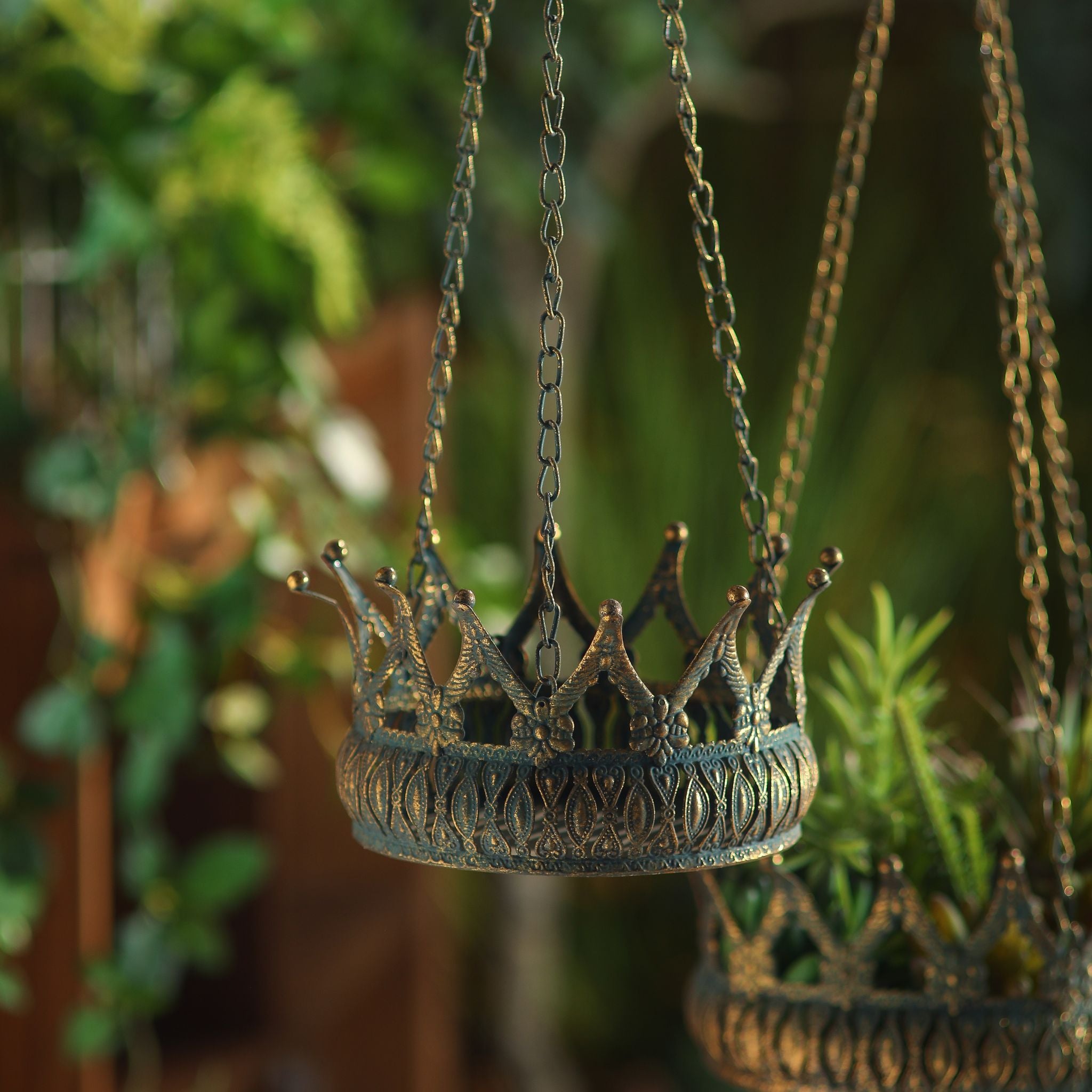 Close-up of the crown points and embossed band on the Annabelle hanging planter, Larger companion inn the background.