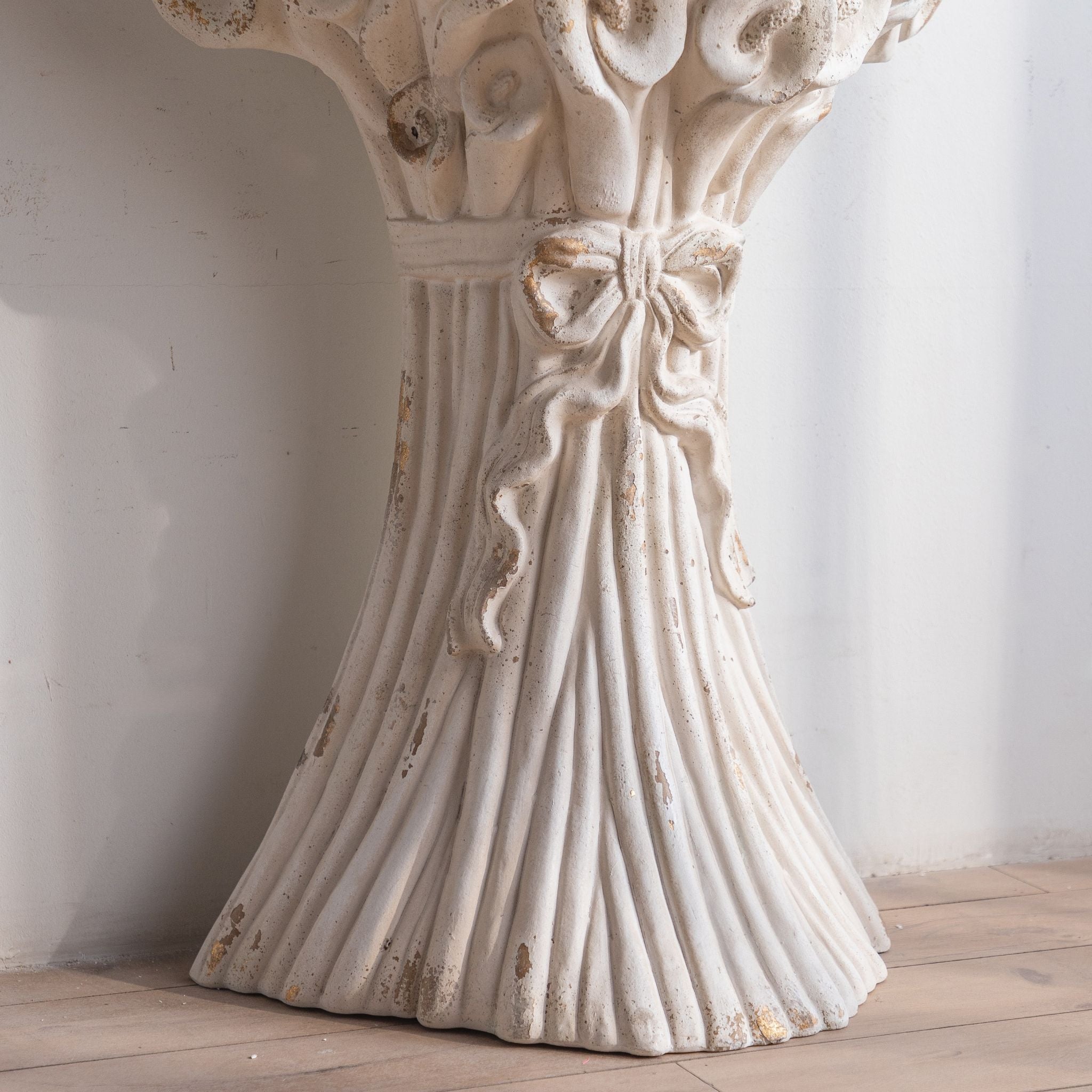 Close-up of the tied bow and fluted sheaf base of the Celestine console