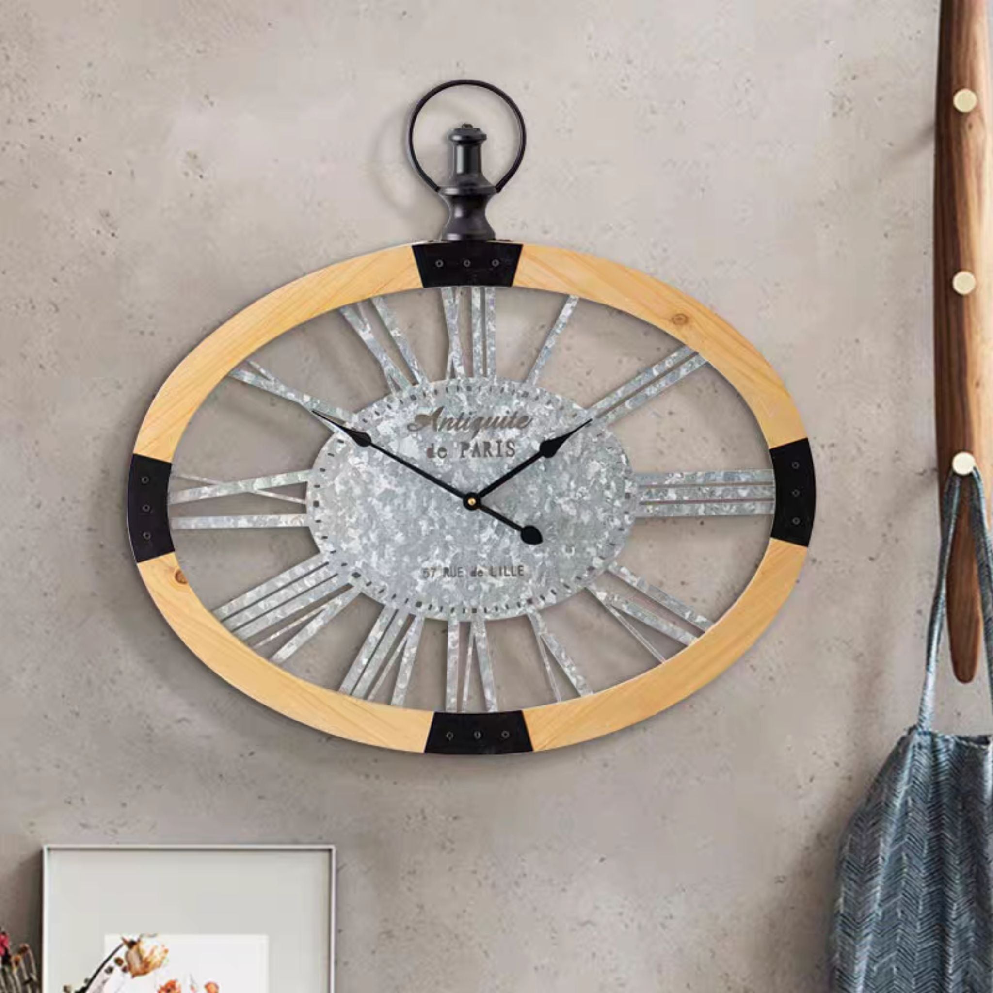 Maude French Provincial oval wall clock with a natural timber frame and galvanised Roman numerals