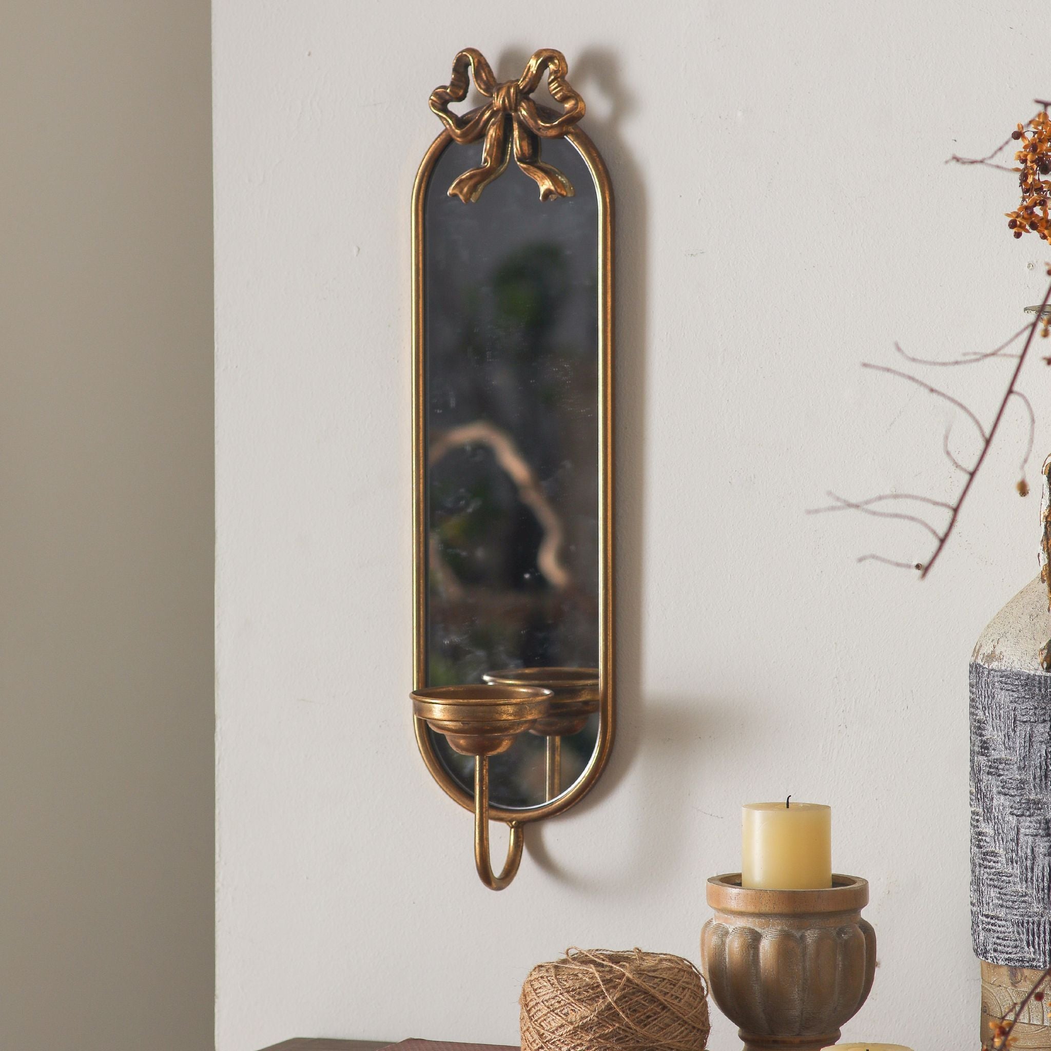 Aude French Provincial mirror candle sconce in aged gold with a bow crest and single candle cup