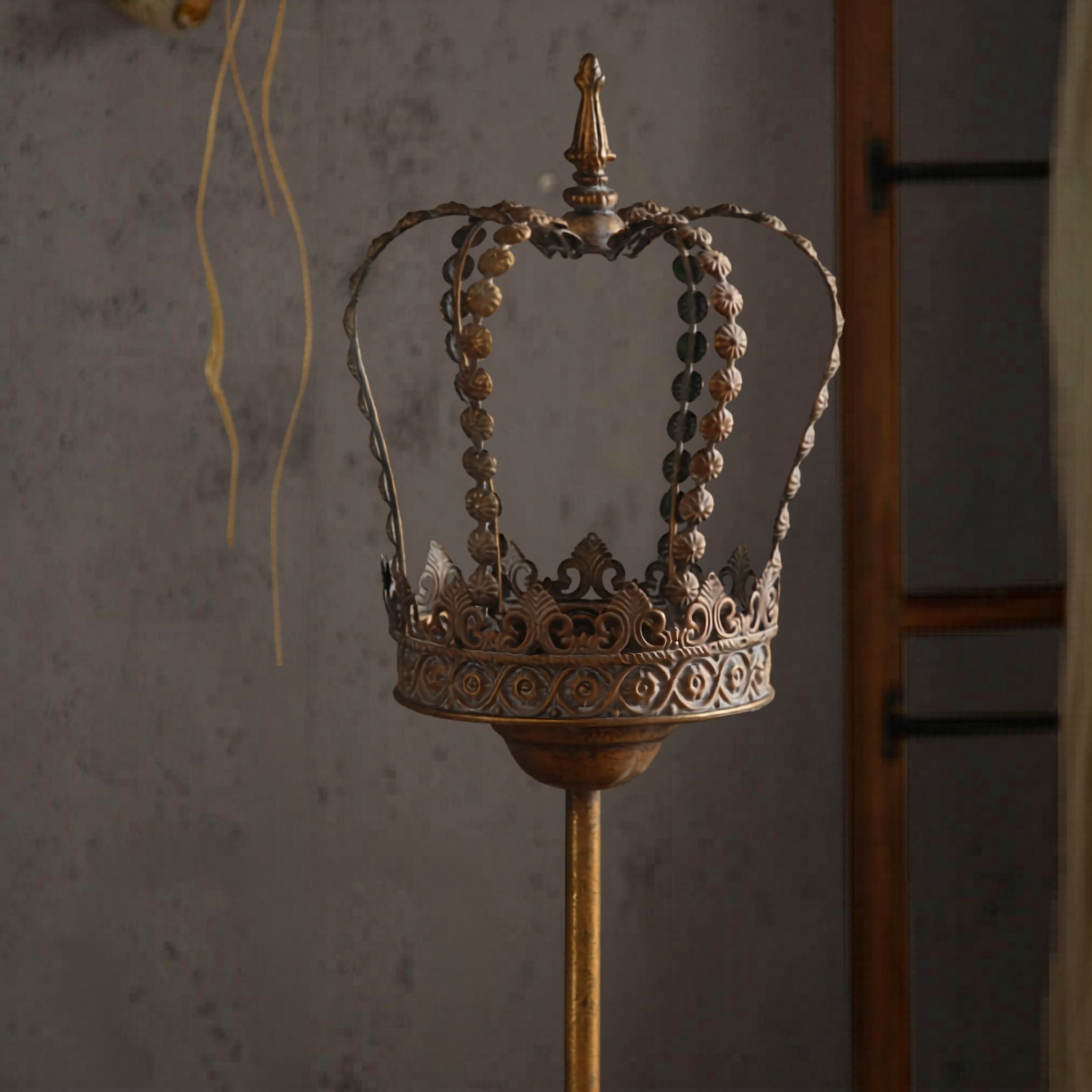 Close-up of openwork antique gold crown with beaded detail and finial