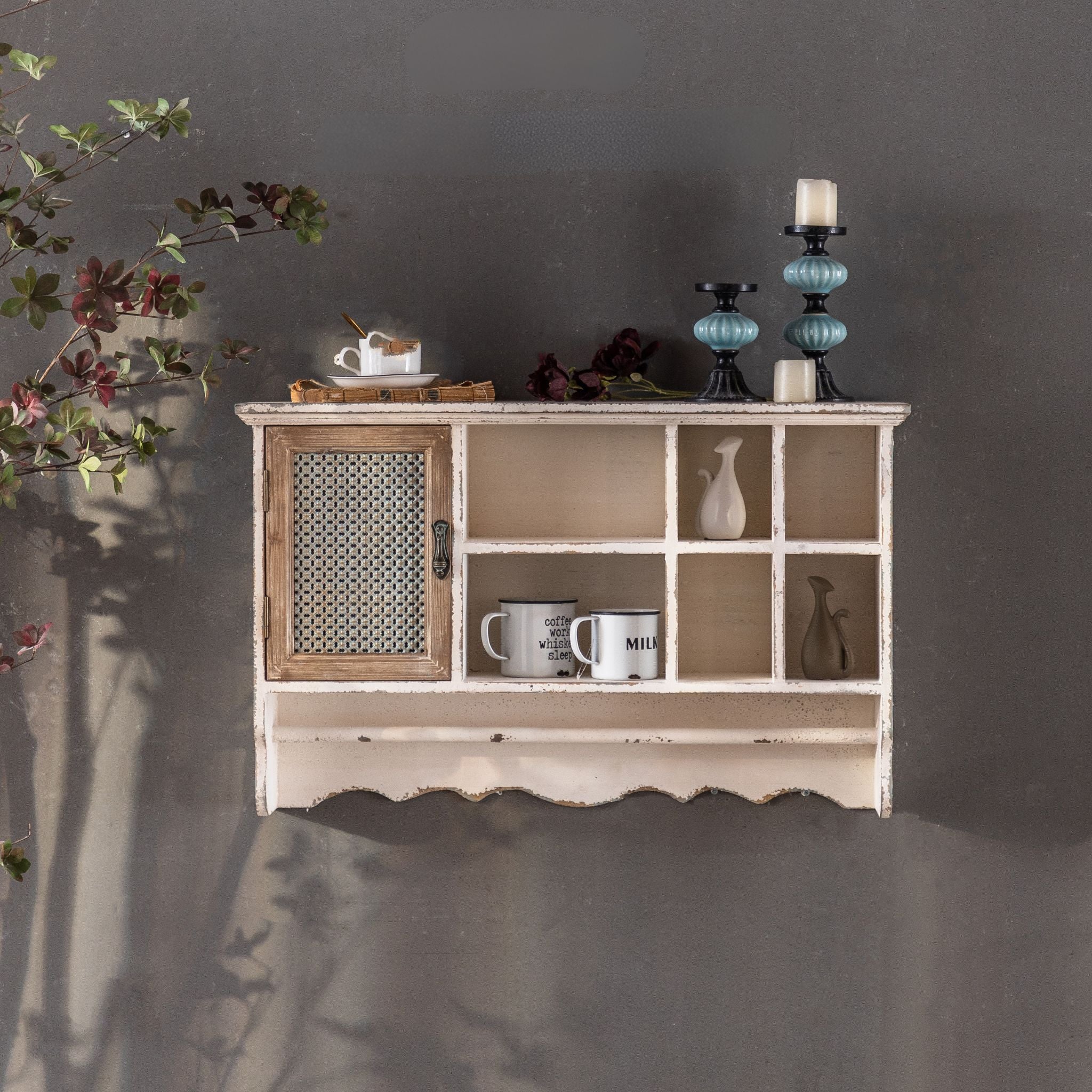 Guy distressed cream wall shelf unit with a mesh-door cupboard, six open cubbies, and a lower rail. Hero.