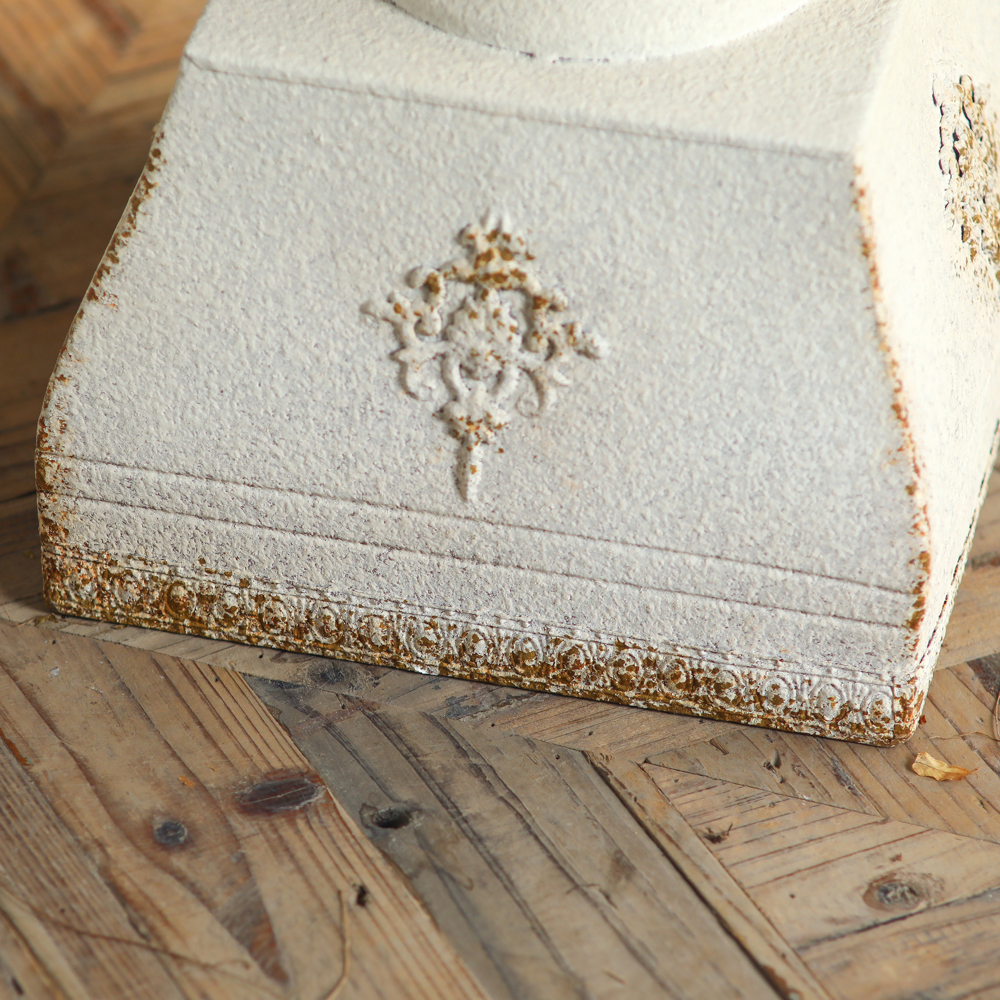 Detail of Héloïse plinth base with embossed medallion and ornamental trim