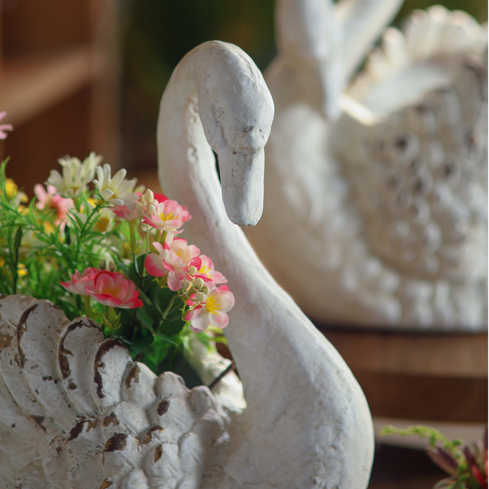 Close-up detail of swan planter head and neck showing hand-finished antique white paintwork and distressed patina