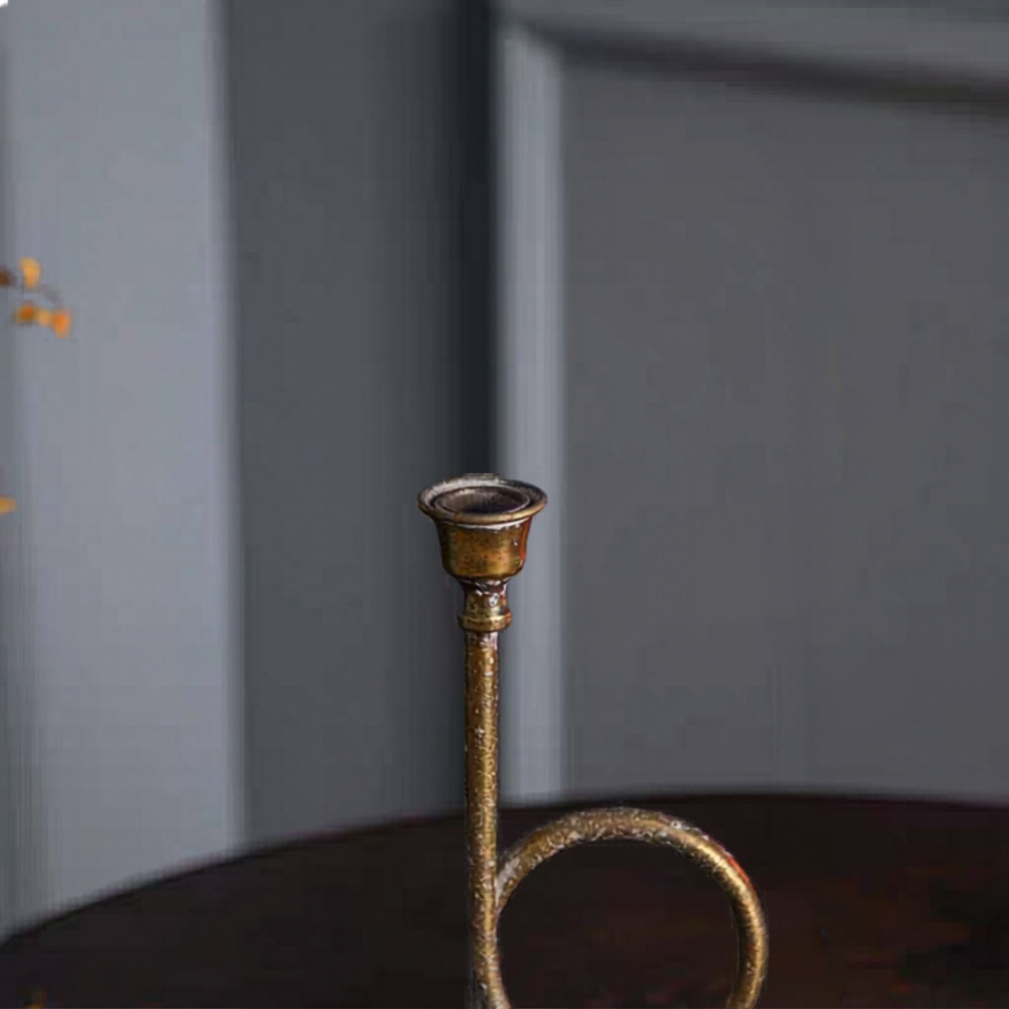 Close-up of the candle cup and stem, gilt-toned antique gold finish.