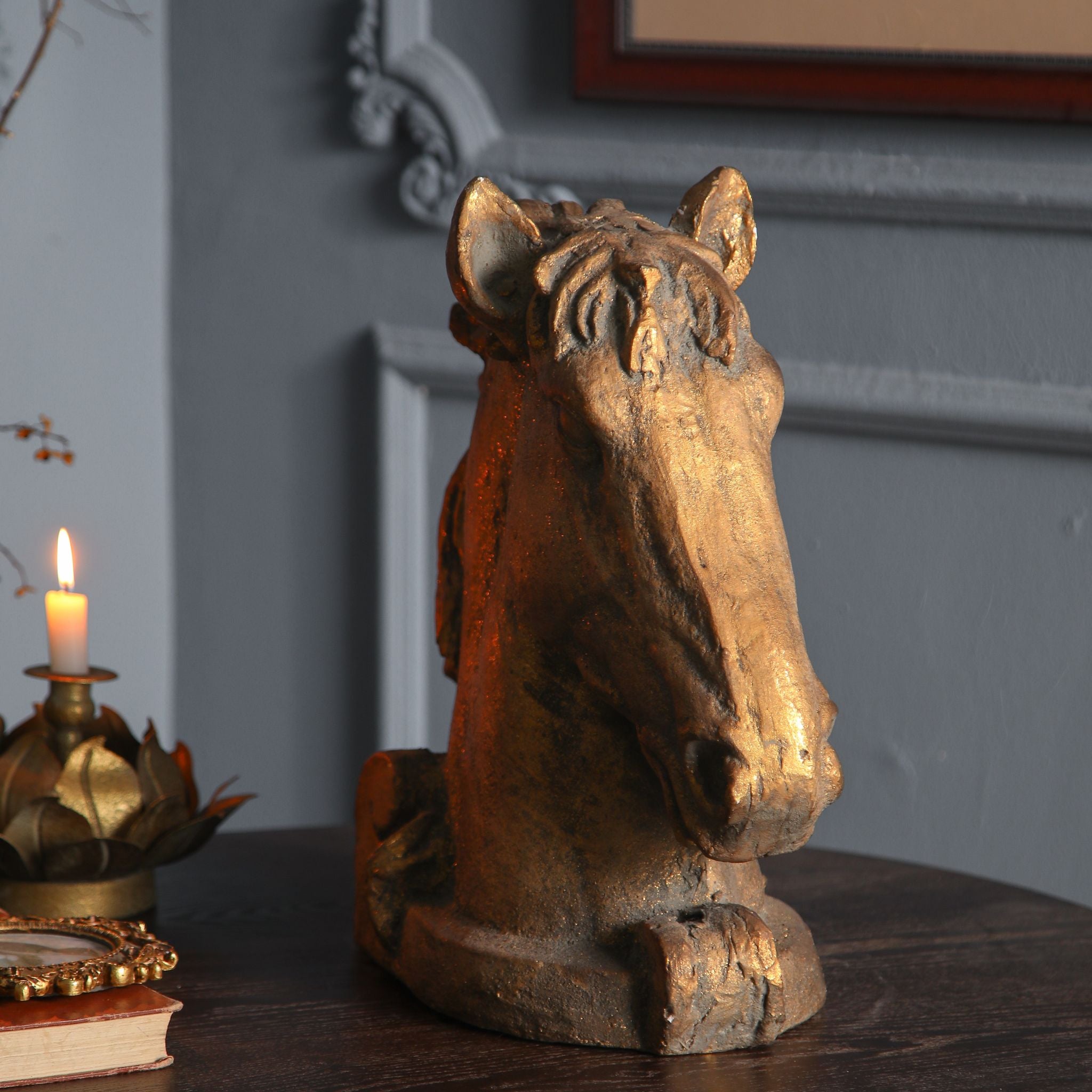 Front three-quarter view of Bayard horse head, gilt finish catching the light over the face