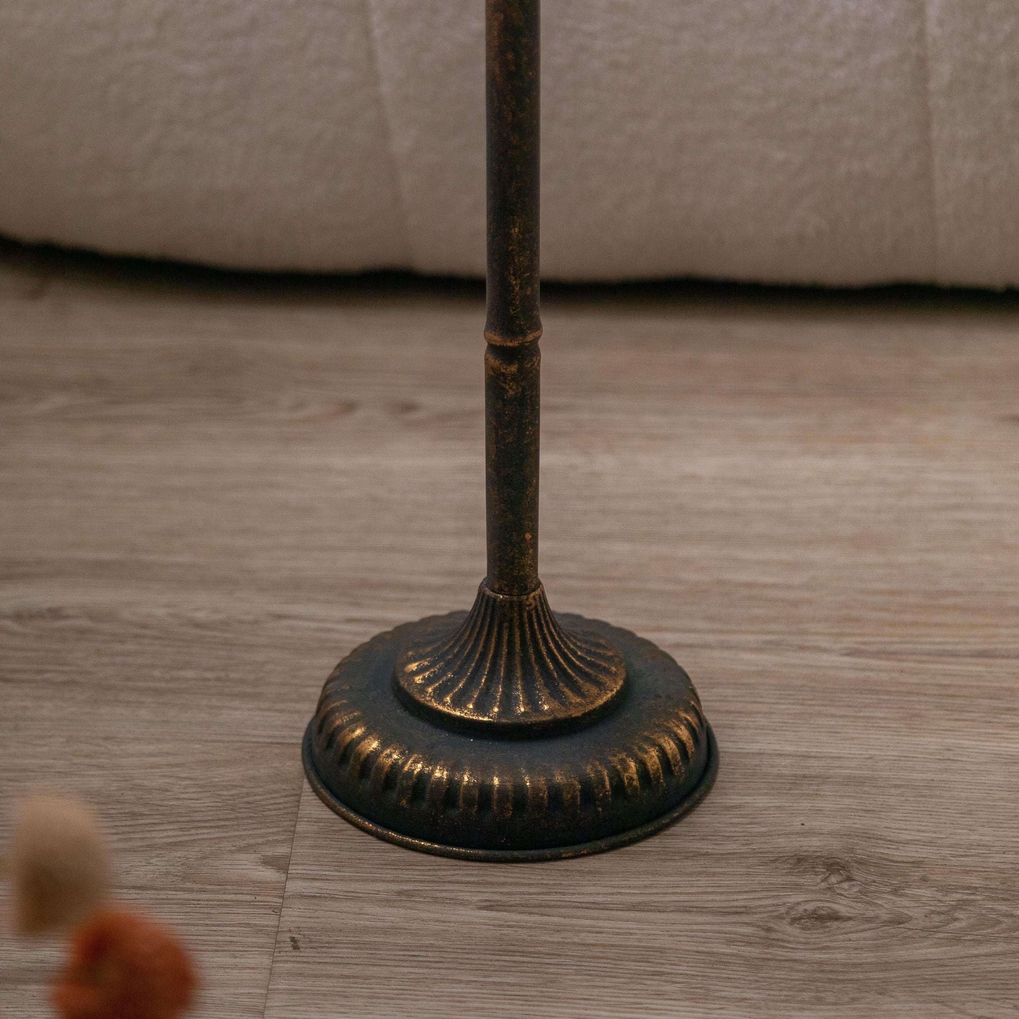 Close-up of the turned stem and openwork cage base in aged metal