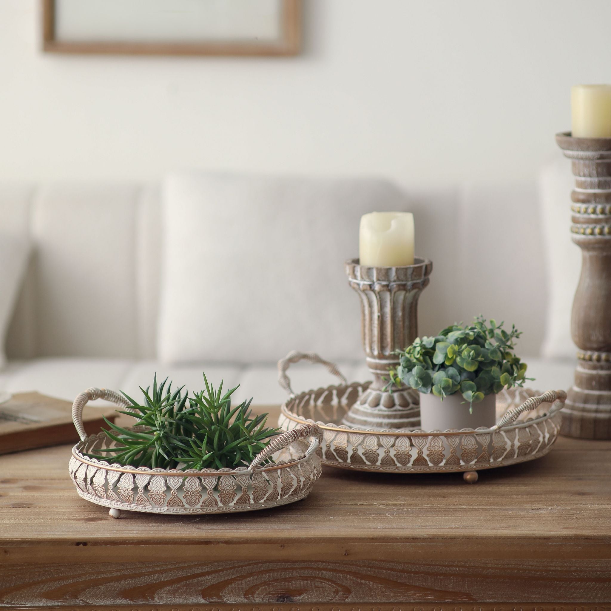 Jewel round trays styled on a table with a candle holder and plant, props not included