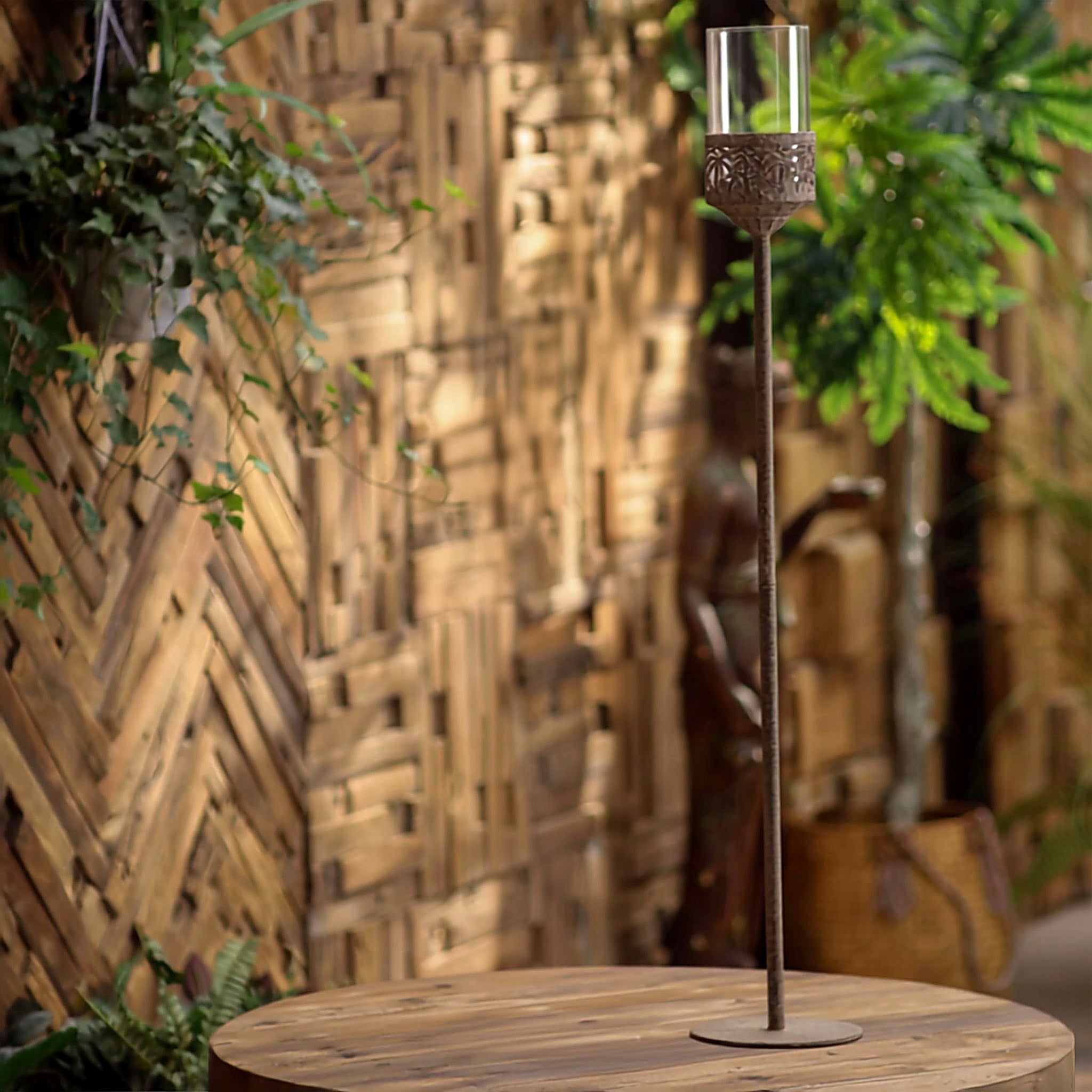 Jonathan floor candle holder standing on a timber verandah beside a doorway