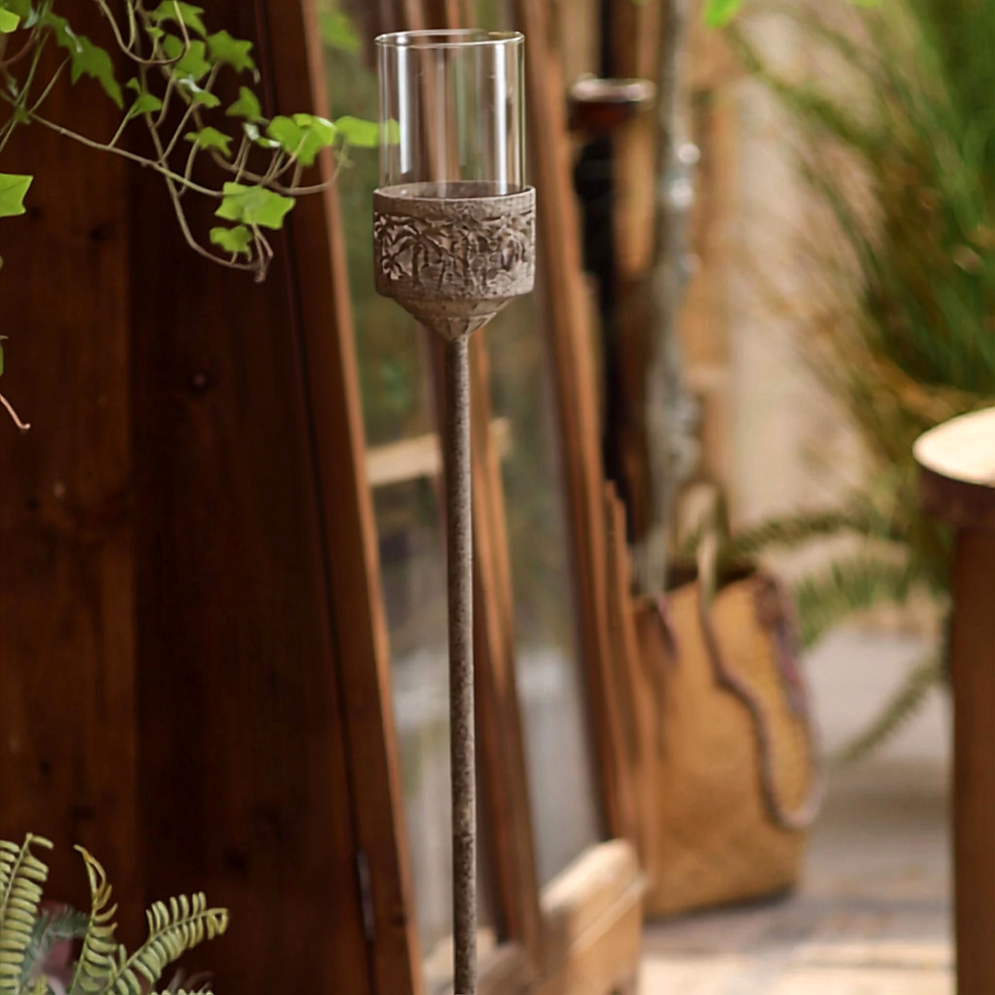 Close up of the pierced whitewashed openwork band and clear glass hurricane cylinder