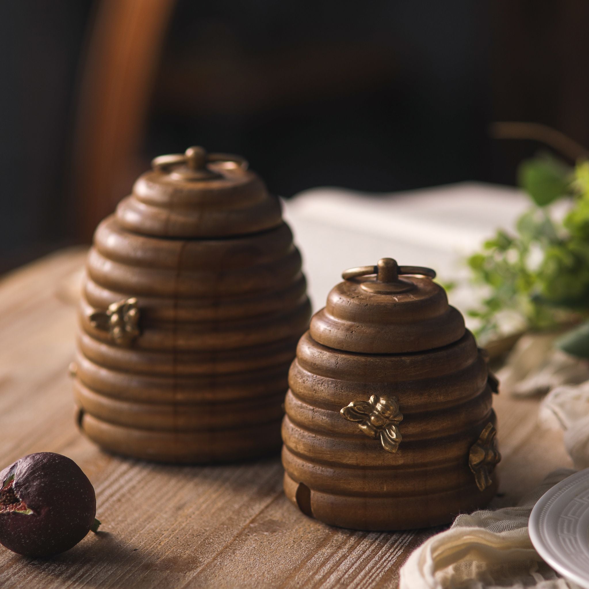 Laure pair of pine beehive honey pots styled on a timber table with figs and greenery.