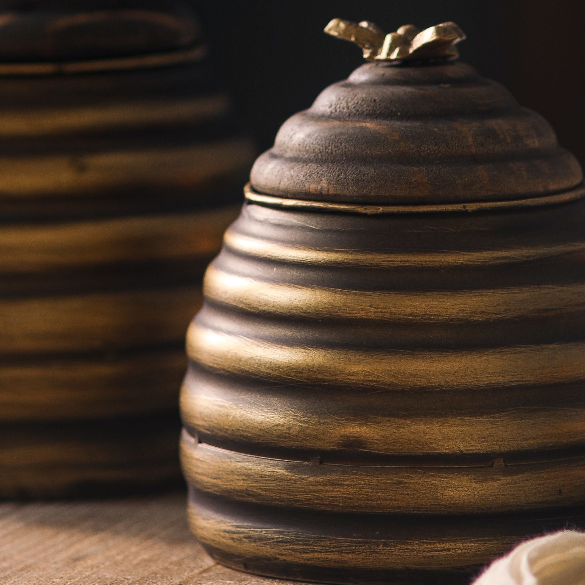 Leonie close-up of the antique gold metal coils and the turned timber lid.