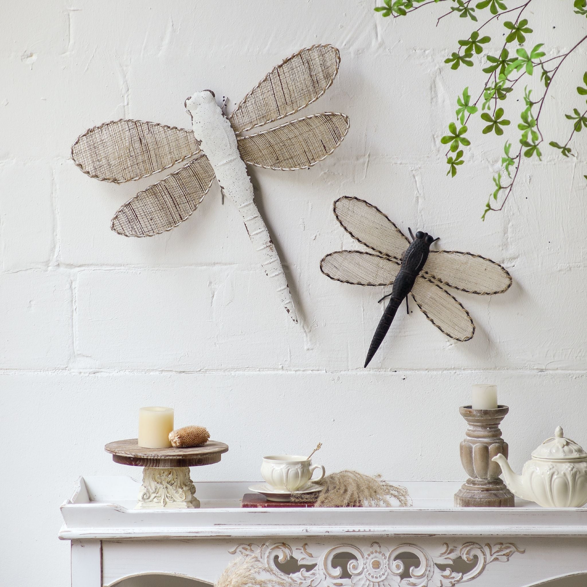 Two dragonfly wall pieces styled together, the larger white Lilly with the smaller dark dragonfly sold separately