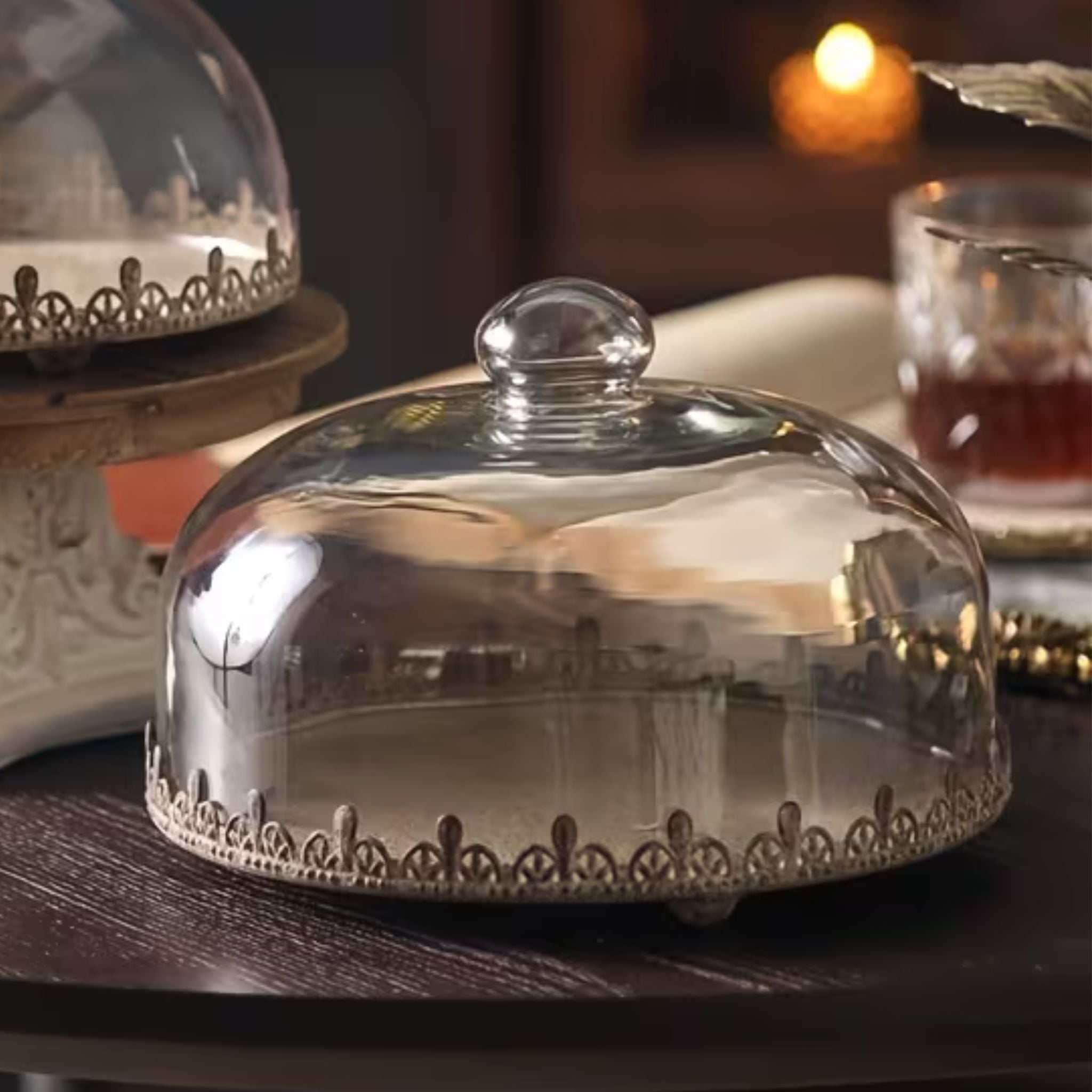 Lilou French Provincial glass cake dome on a footed metal tray with a pierced crown edge in rustic rust-brown