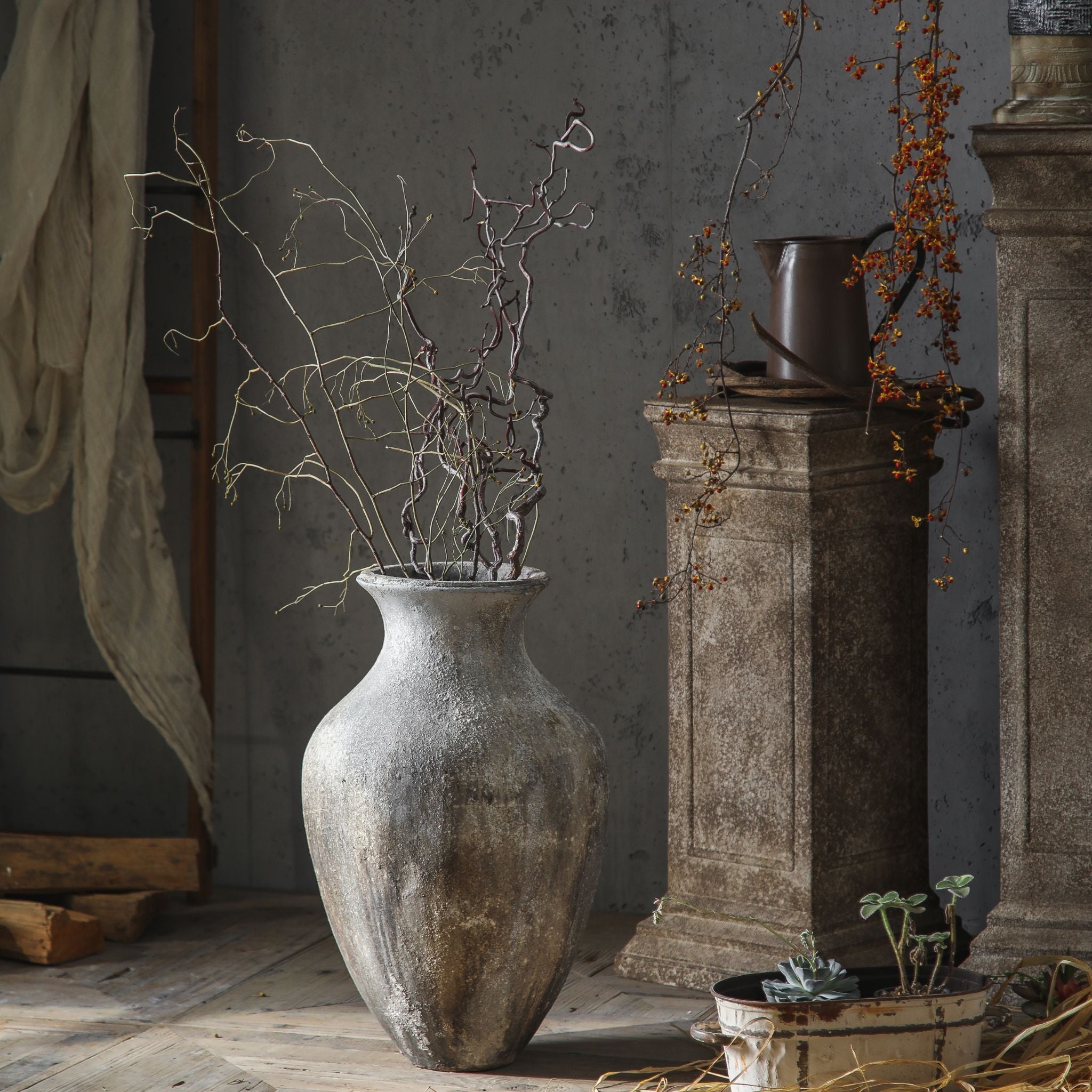 Lionel floor vase styled with branches in a French provincial room