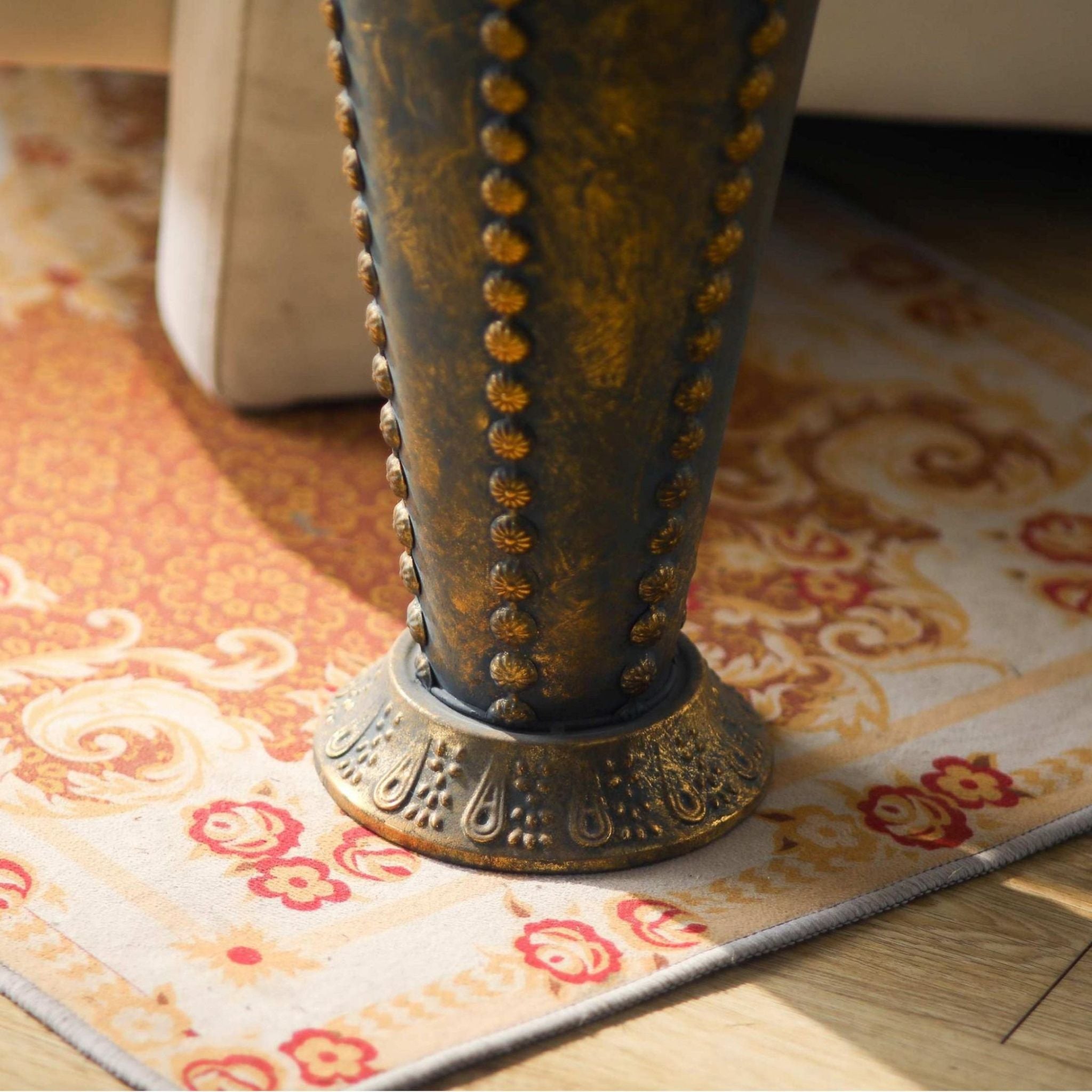Embossed flared foot and studded lower body of the Luna umbrella stand.