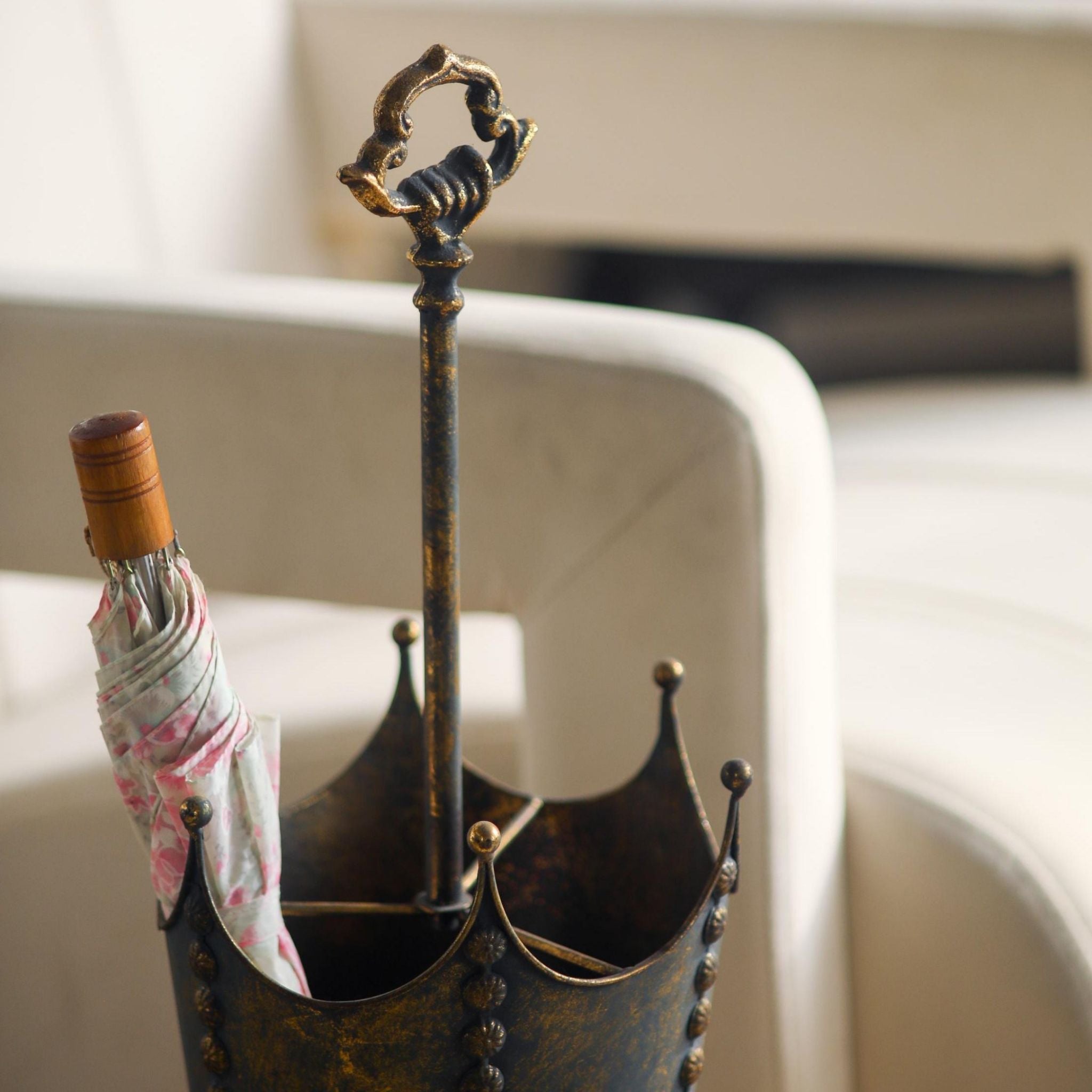 Ornate scrolled handle at the top of the Luna umbrella stand.