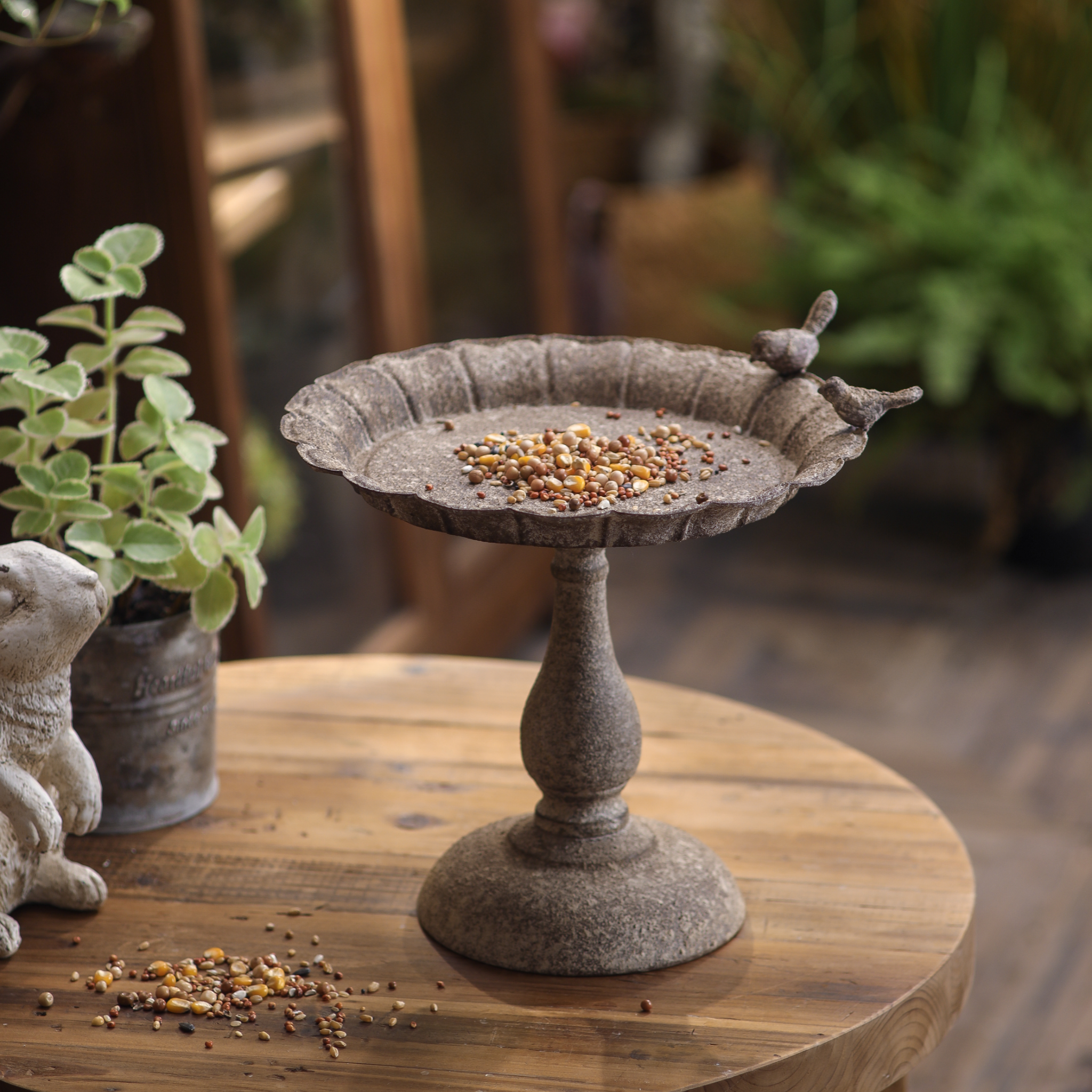 Side view of Manon French Provincial bird feeder showing fluted dish and turned pedestal base