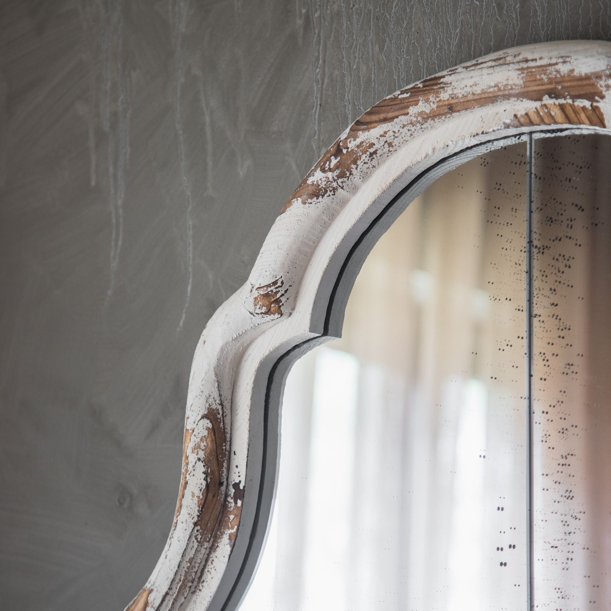 Close-up of the Marion mirror's serpentine arched top and distressed white over timber frame