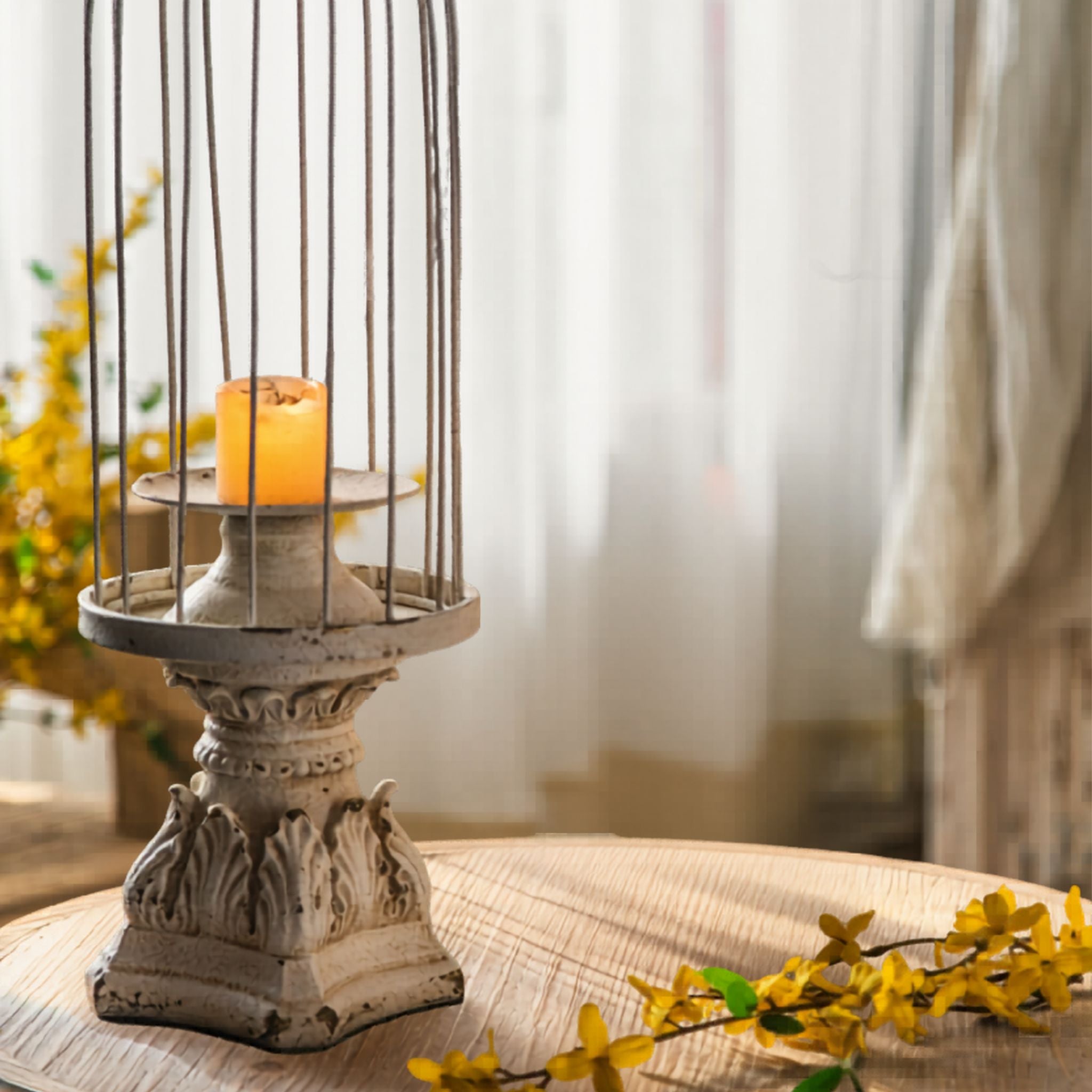 Close-up of the Matheo candle plate, turned pedestal and acanthus leaf base in distressed white worn to terracotta.
