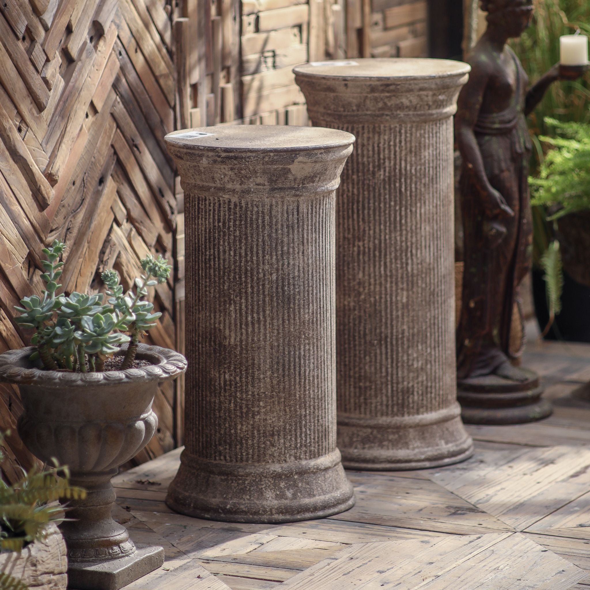 Mireille shorter fluted column pedestal beside the taller matching column from the same series.