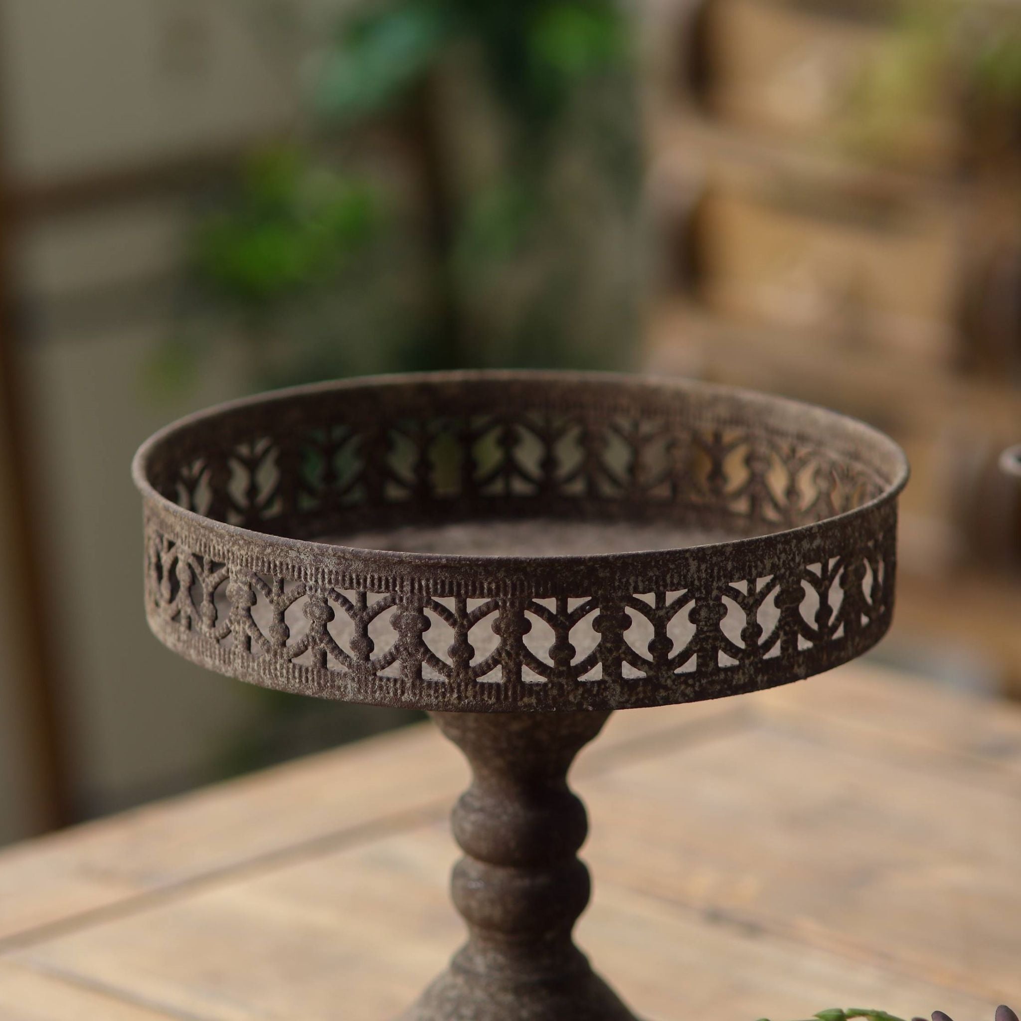 Mirielle pedestal stand side view showing the turned stem and flared round foot.