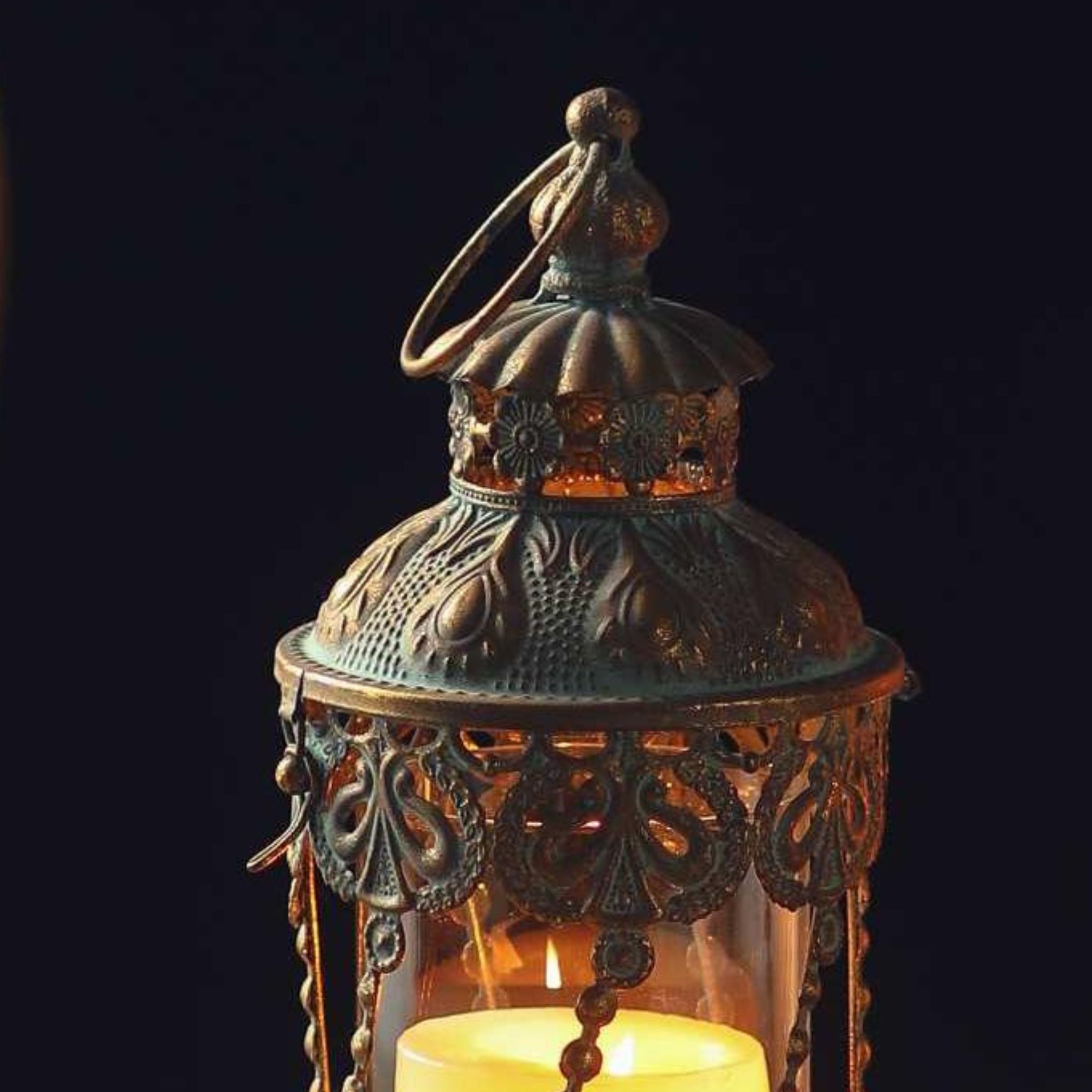 Close detail of the Mylan lantern dome, embossed antique gold with verdigris, pierced filigree skirt, ring handle and beaded chains.