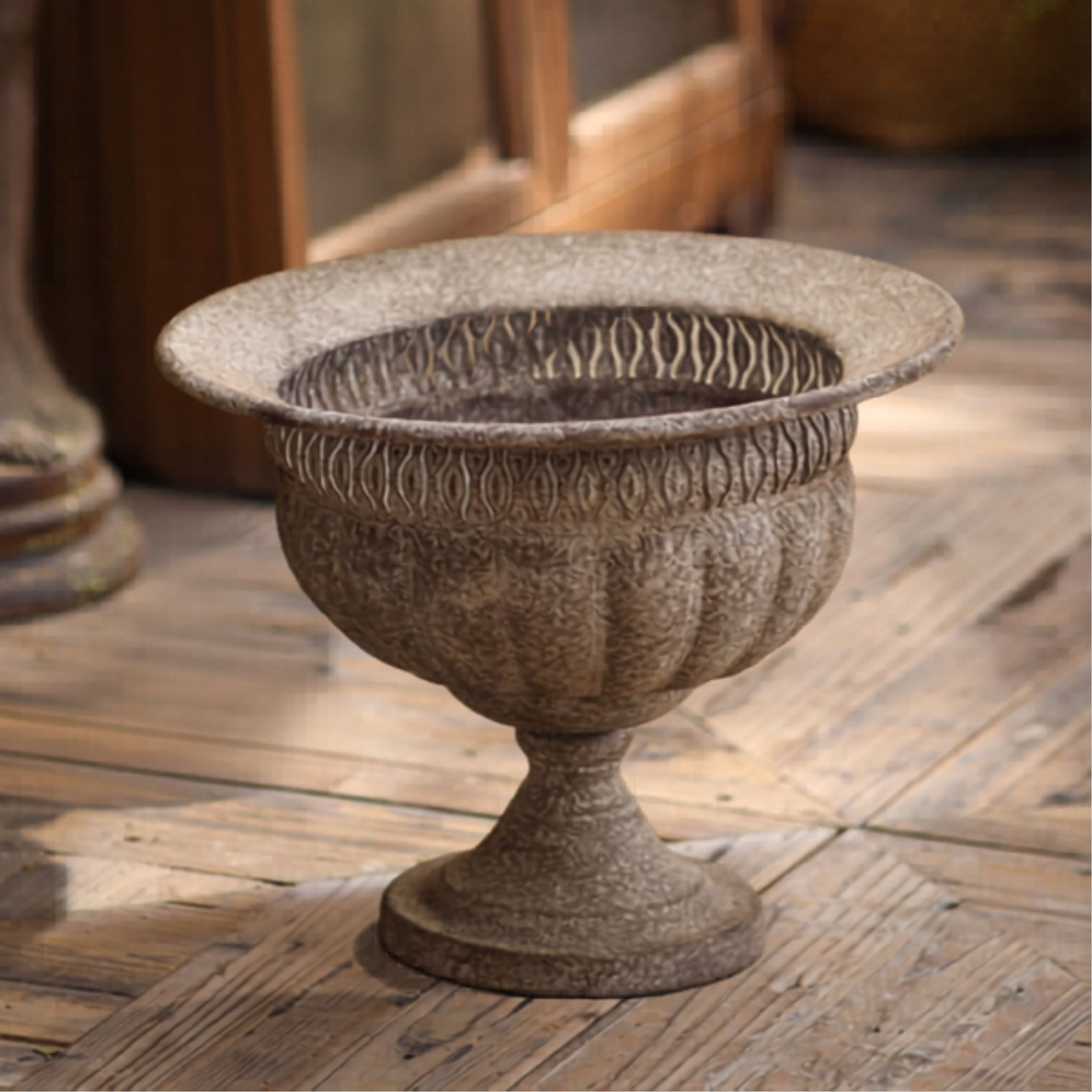 Myriam footed urn planter front on, flared rim, fluted bowl and pedestal foot in weathered grey and buff.