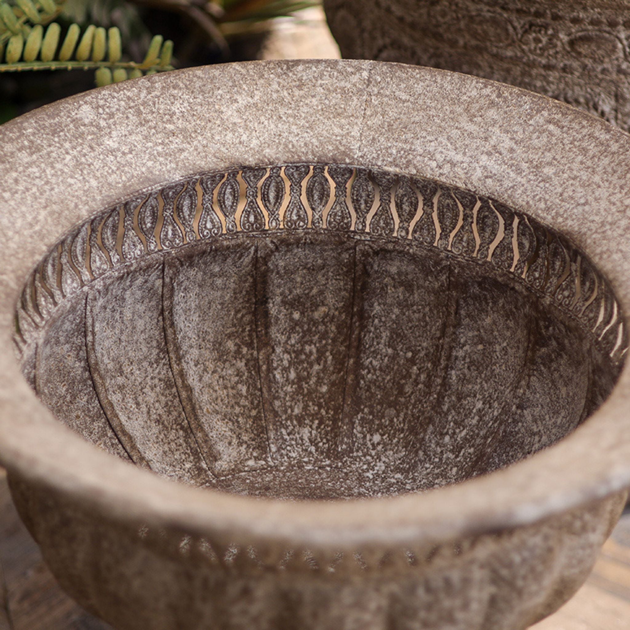 Top-down view into the Myriam urn showing the pierced openwork rim band and the ribbed interior.