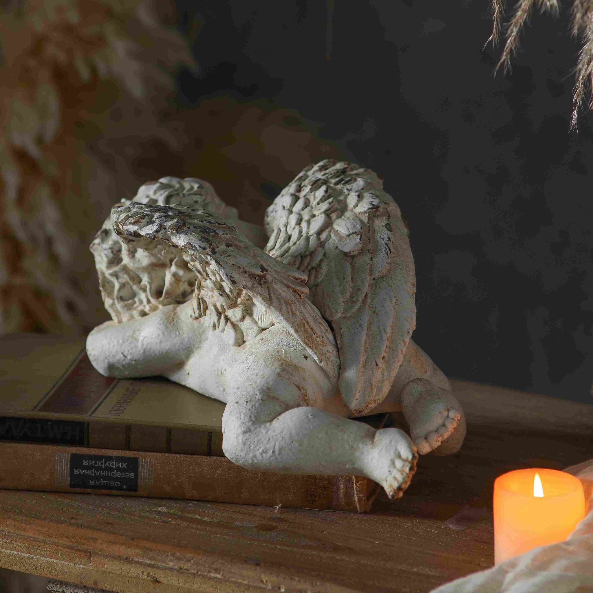 Close-up of Océane sleeping cherub showing the peaceful sleeping face with curled hair, folded wings, and warm undertone wear across the heavily distressed whitewash