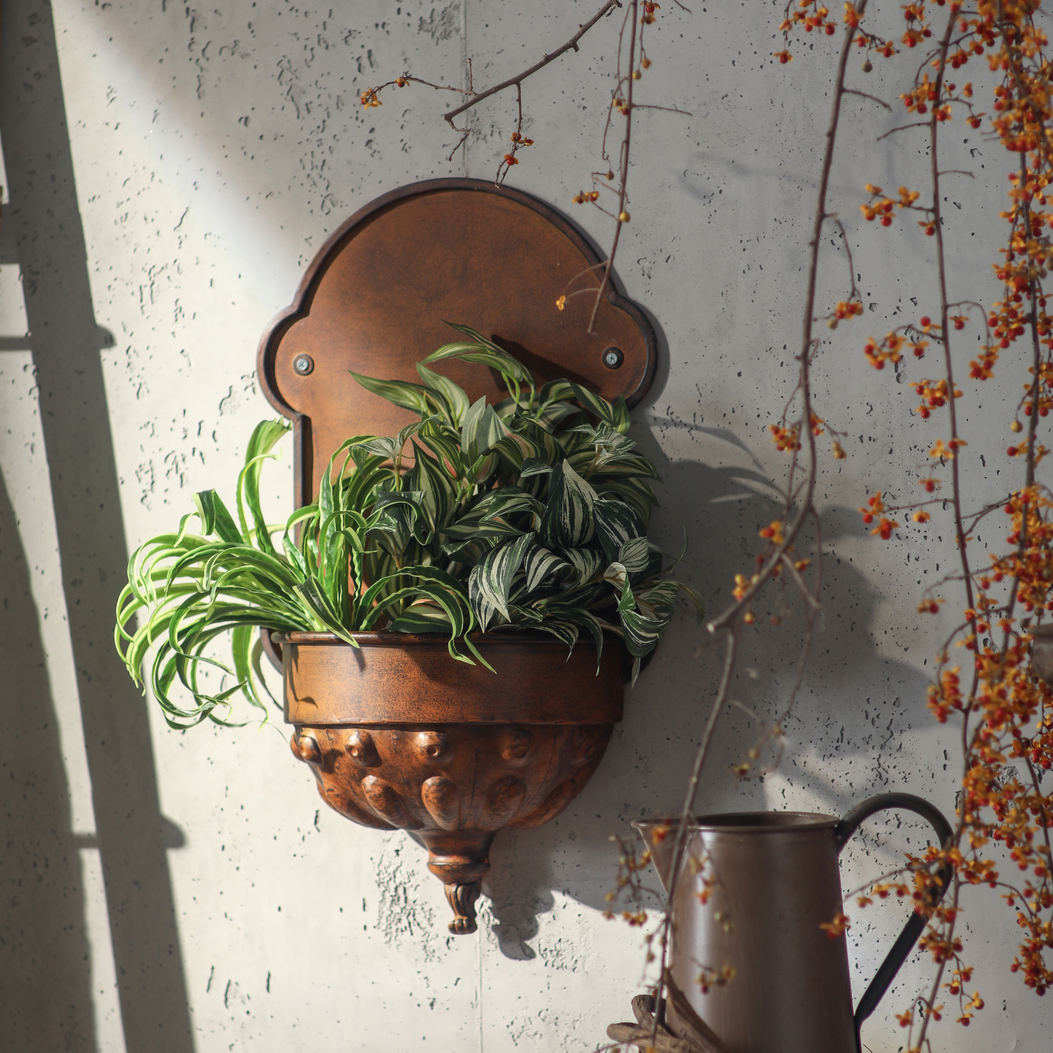 Olivier wall planter styled with cascading plants in warm afternoon light